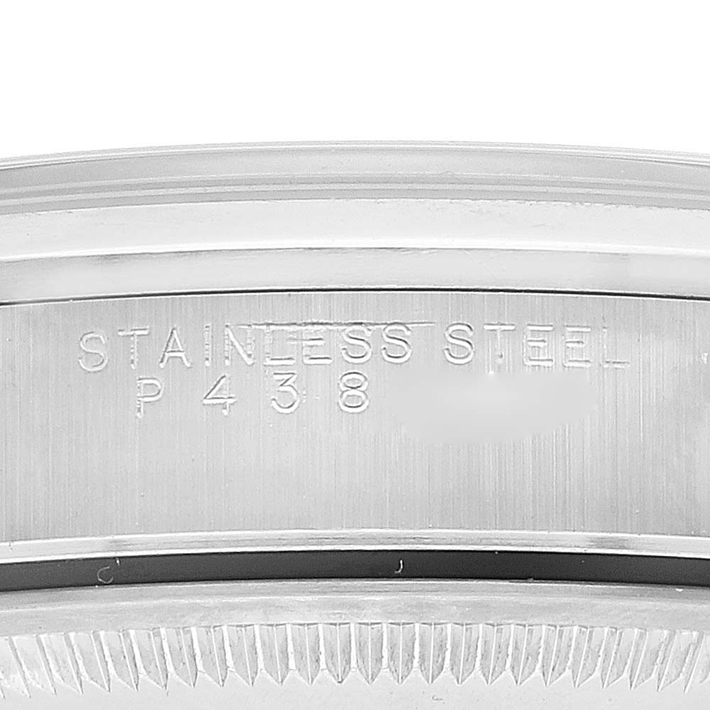 This image shows a close-up of the engraved stainless steel inscription on the inner bezel of a Rolex Date 15200 Men's Stainless Steel White Dial 15200 Men's Stainless Steel White Dial watch.