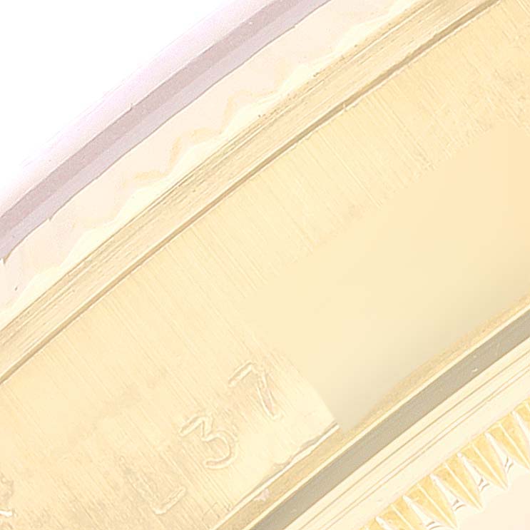 The image shows a close-up angle of the bezel and part of the band of a Rolex Date 15238 Men's Yellow Gold White Dial 15238 Men's Yellow Gold White Dial model watch.