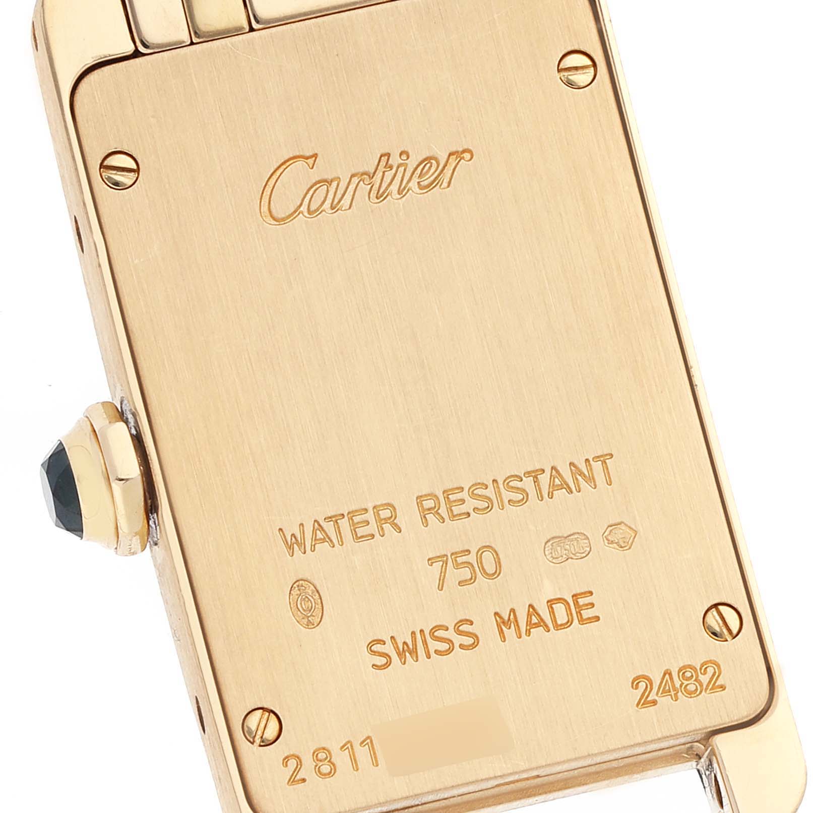 The image shows the back case of the Tank Americaine model by Cartier, highlighting its engravings and crown.