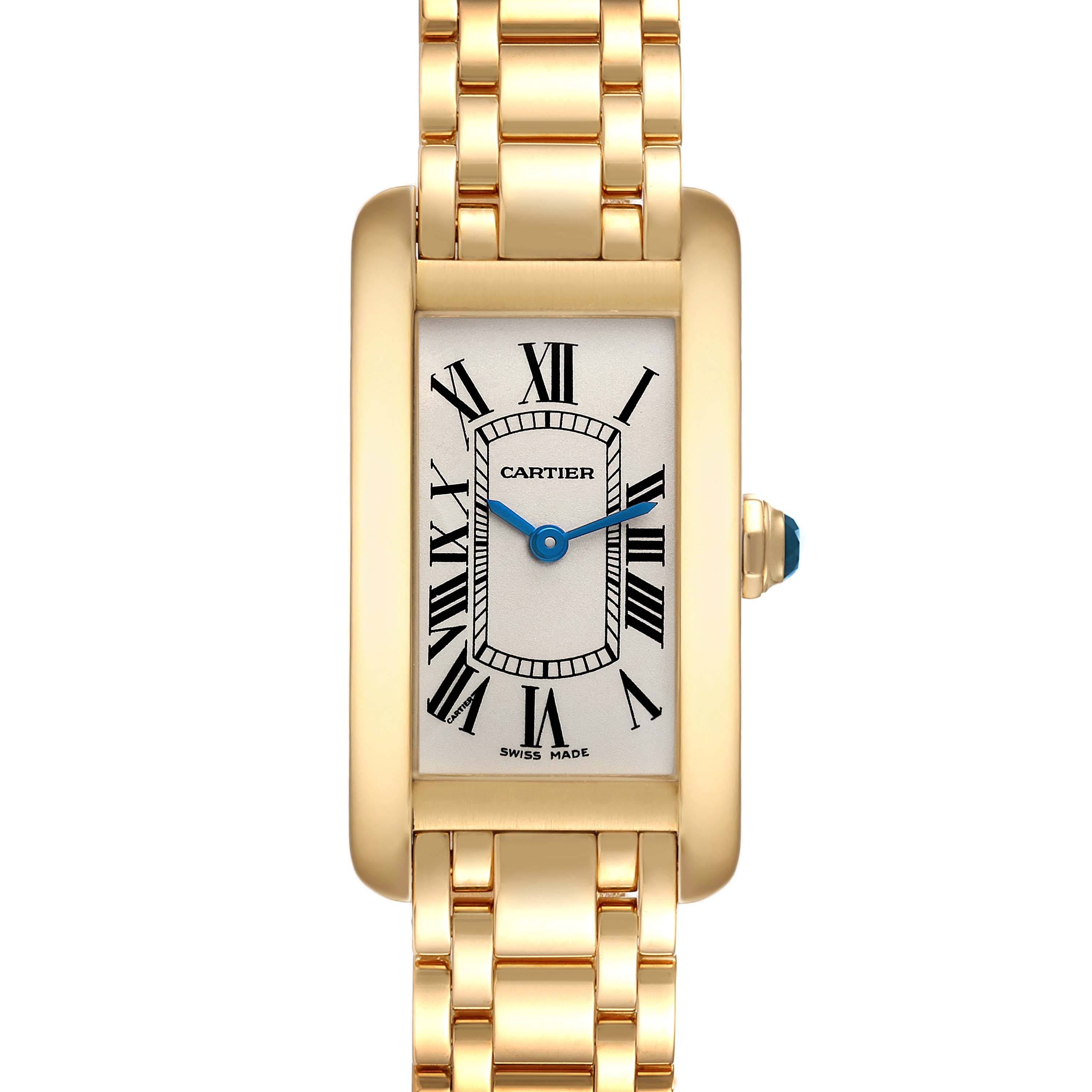 The image shows a front view of the Cartier Tank Americaine W26015K2 Women's Yellow Gold Silver Dial W26015K2 Women's Yellow Gold Silver Dial watch, highlighting its gold case, Roman numerals, and blue hands.