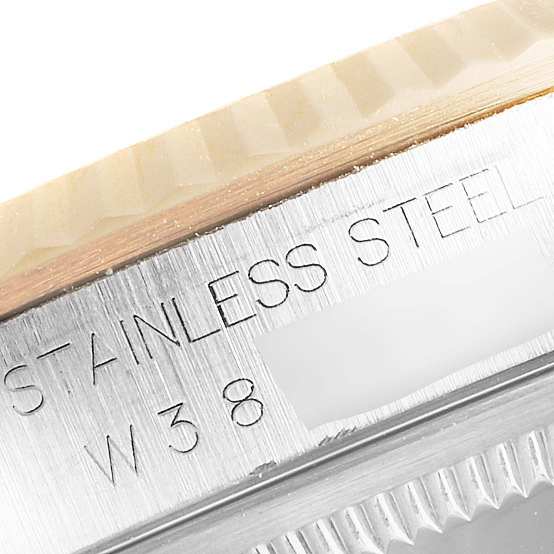 This close-up angle shows the stainless steel engravings and fluted bezel of the Rolex Datejust 16233 Men's Steel and Gold (two tone) Champagne Dial 16233 Men's Steel and Gold (two tone) Champagne Dial model.