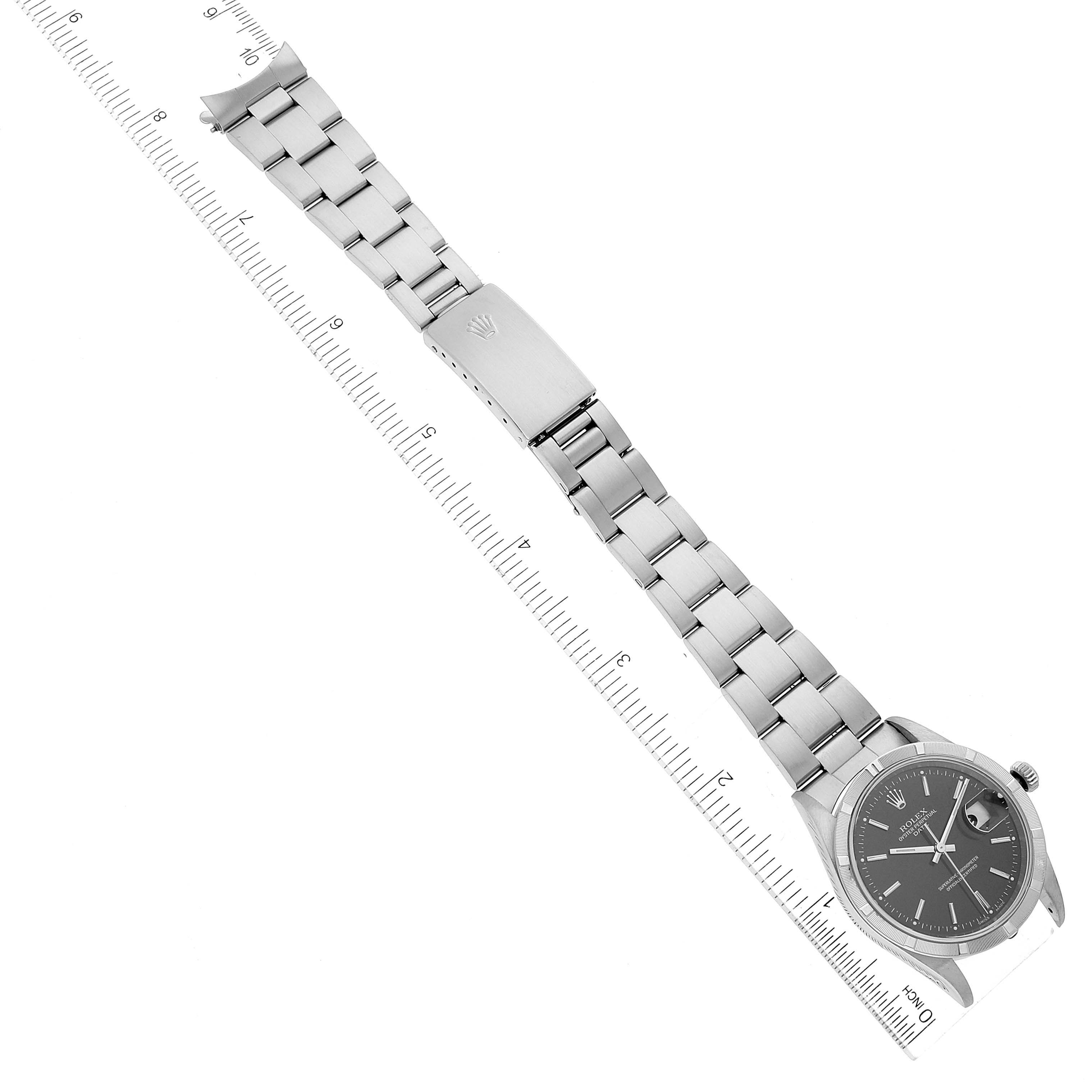 This image shows the Rolex Date 15210 Men's Stainless Steel Black Dial 15210 Men's Stainless Steel Black Dial model watch, displaying the entire face and bracelet, with a ruler for scale measurement.