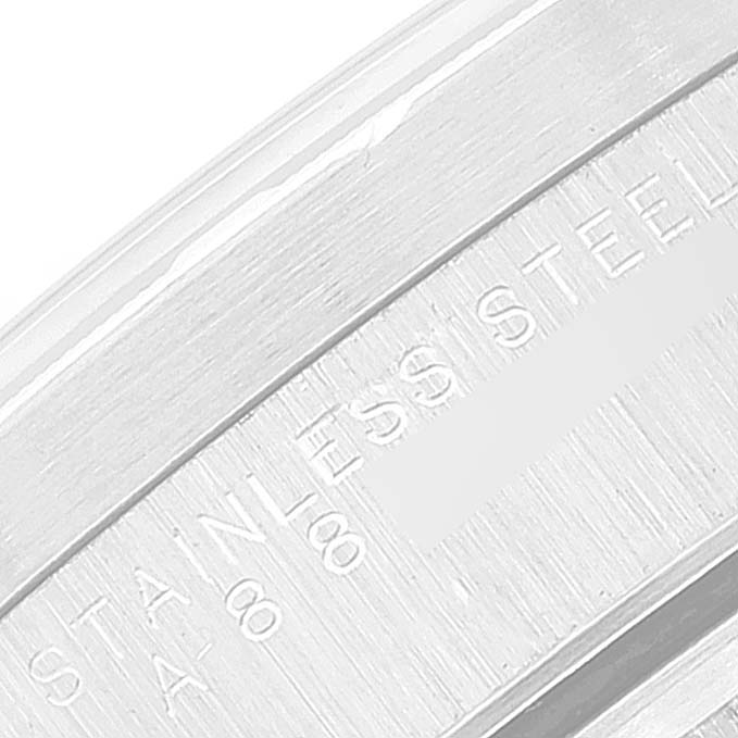 The image shows a close-up of the stainless steel caseback of a Rolex Date 15210 Men's Stainless Steel Black Dial 15210 Men's Stainless Steel Black Dial model watch, showcasing the engravings.