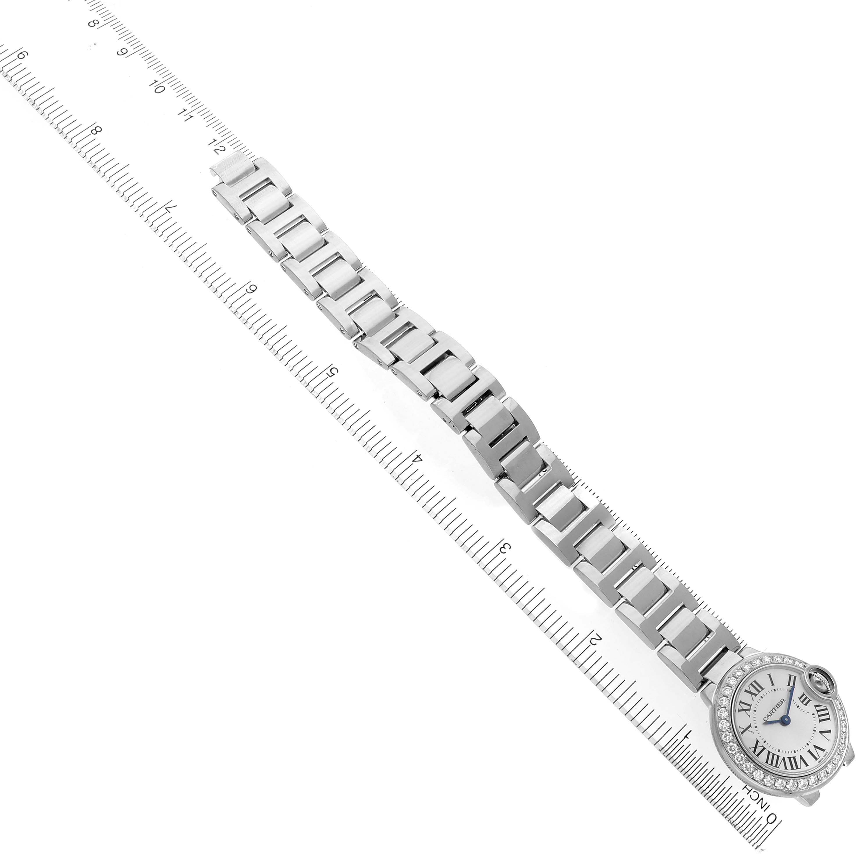 The Cartier Ballon Bleu WE9003Z3 Women's White Gold Silver Dial WE9003Z3 Women's White Gold Silver Dial watch is shown from a top view with its bracelet extended along a ruler.