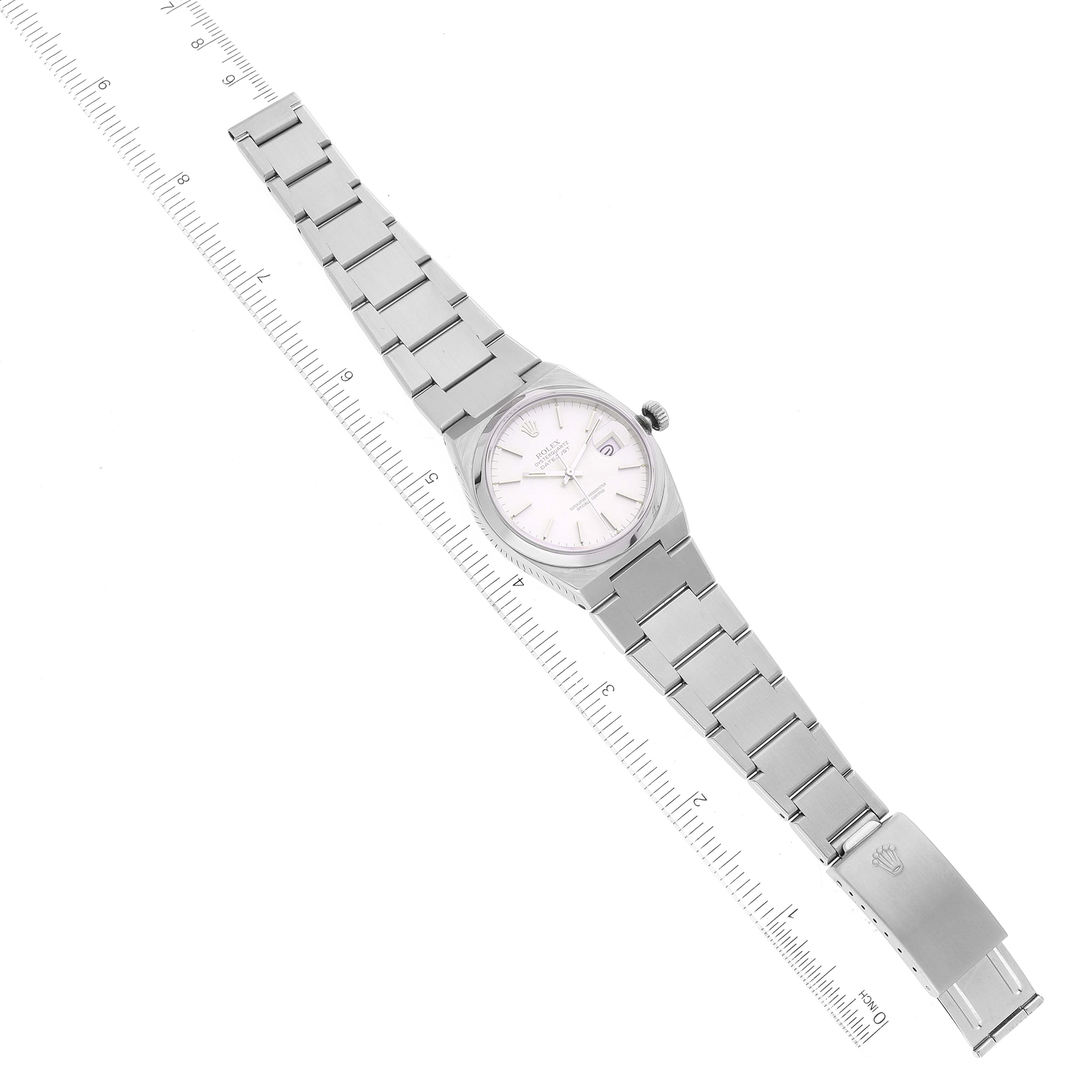 The Rolex Oysterquartz 17000 Men's Stainless Steel Silver Dial 17000 Men's Stainless Steel Silver Dial watch is shown from a top-down angle, featuring the full bracelet and dial, alongside a ruler for size reference.