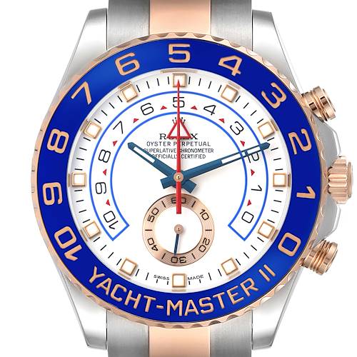 The image shows the Rolex Yacht-Master 116681M Men's Steel and Gold (two tone) White Dial II watch from a front angle, highlighting its blue bezel and detailed dial.