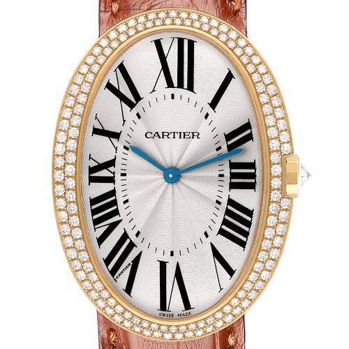 The Cartier Baignoire WB520005 Women's Yellow Gold Silver Dial watch is shown from a top-down angle, highlighting its oval face, roman numerals, diamond bezel, and leather strap.