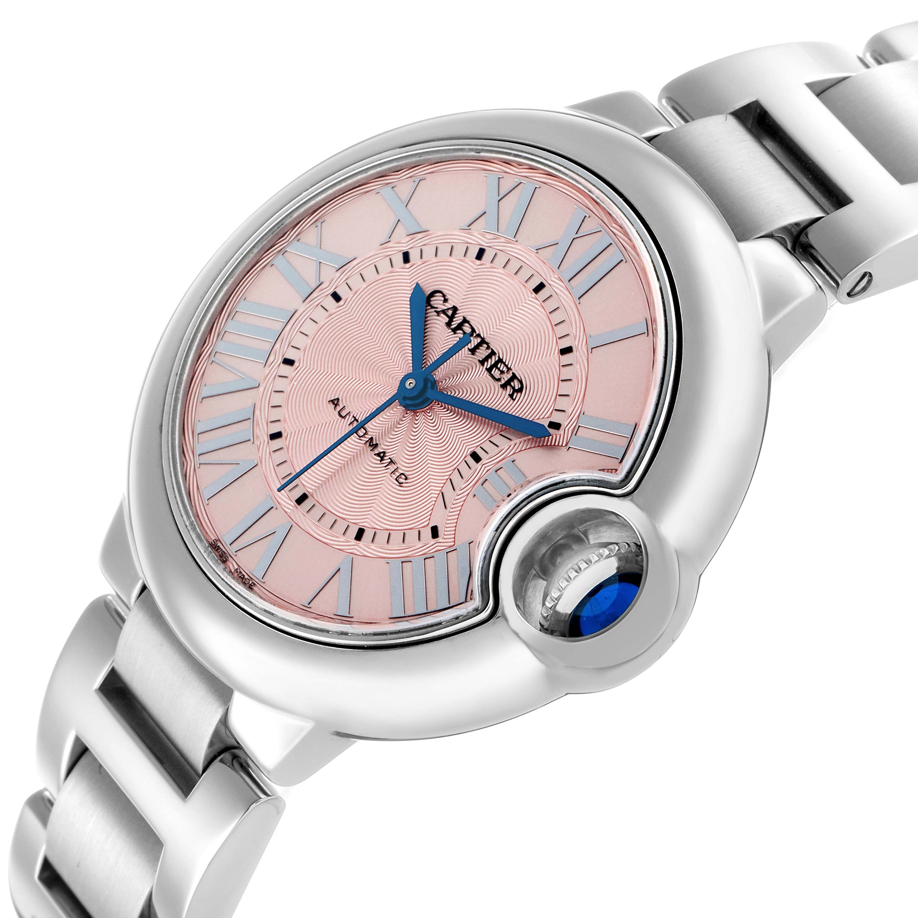 The image shows the Cartier Ballon Bleu WSBB0046 Men's Stainless Steel Pink Dial watch at an angle highlighting the face, crown, and part of the bracelet.