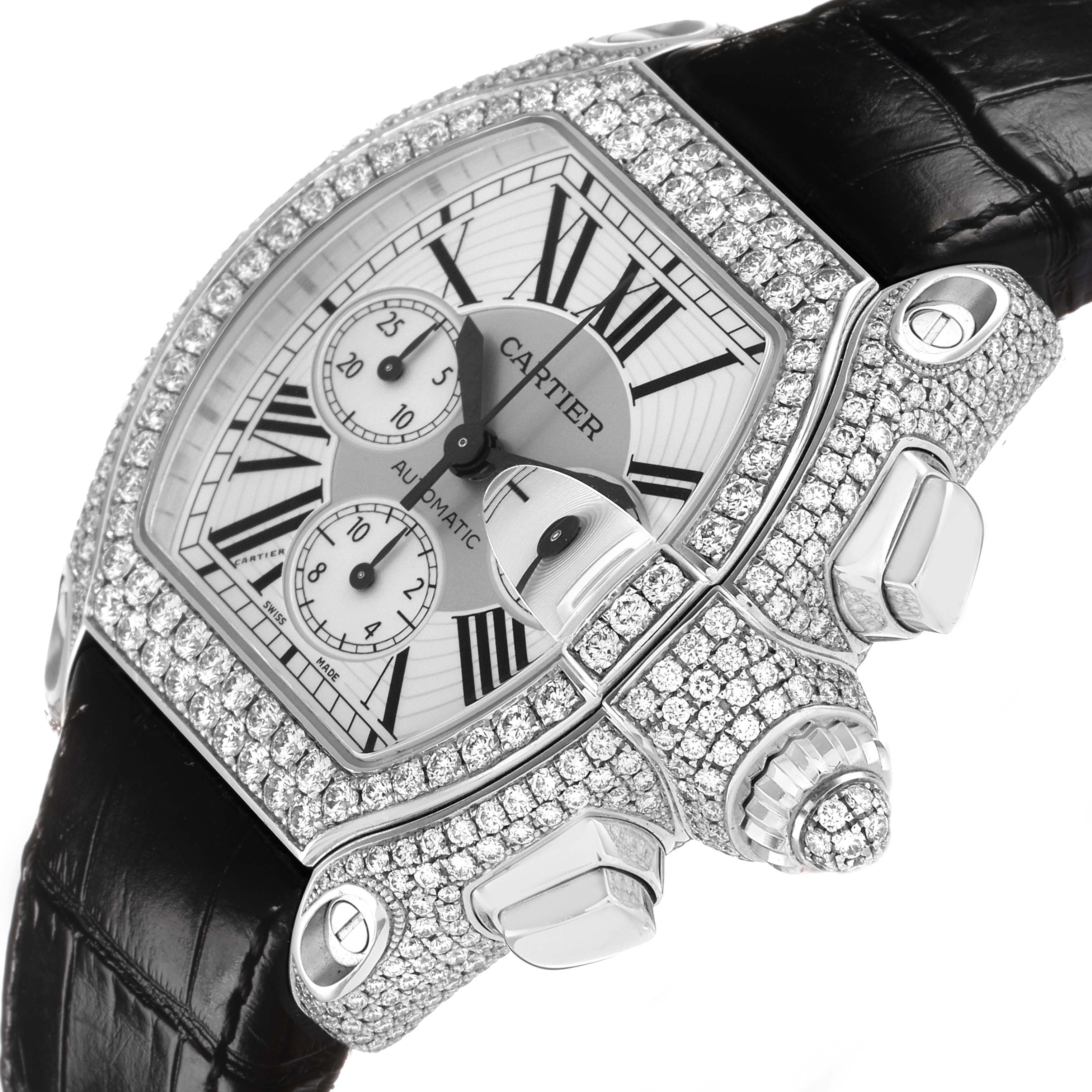 The Cartier Roadster WE50032H Men's White Gold Silver Dial watch is shown at a tilted angle, highlighting the diamond-encrusted case, crown, and black strap.