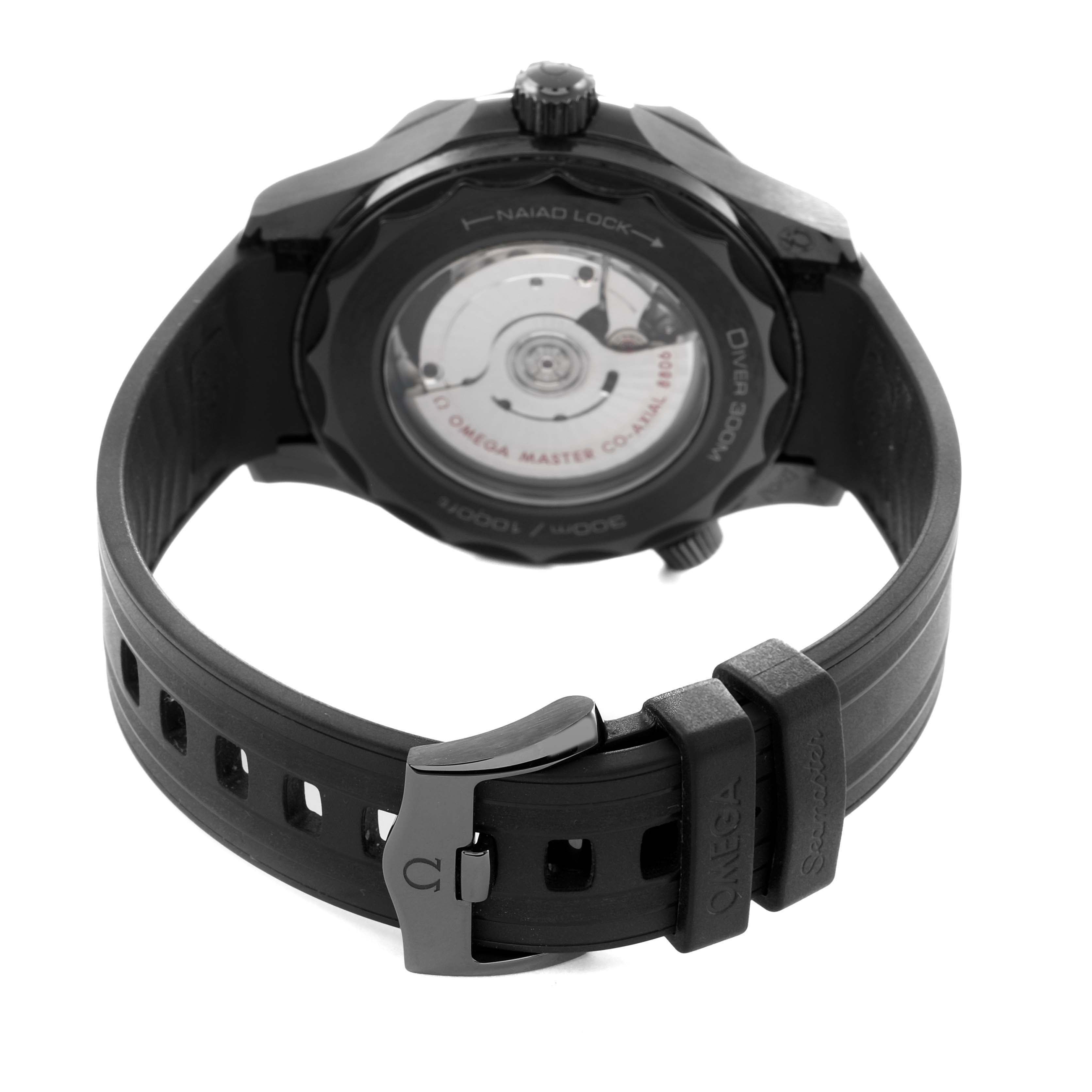 The image shows the back of an Omega Seamaster 210.92.44.20.01.003 Men's Ceramic Black Dial watch, focusing on the case back and black rubber strap with clasp.