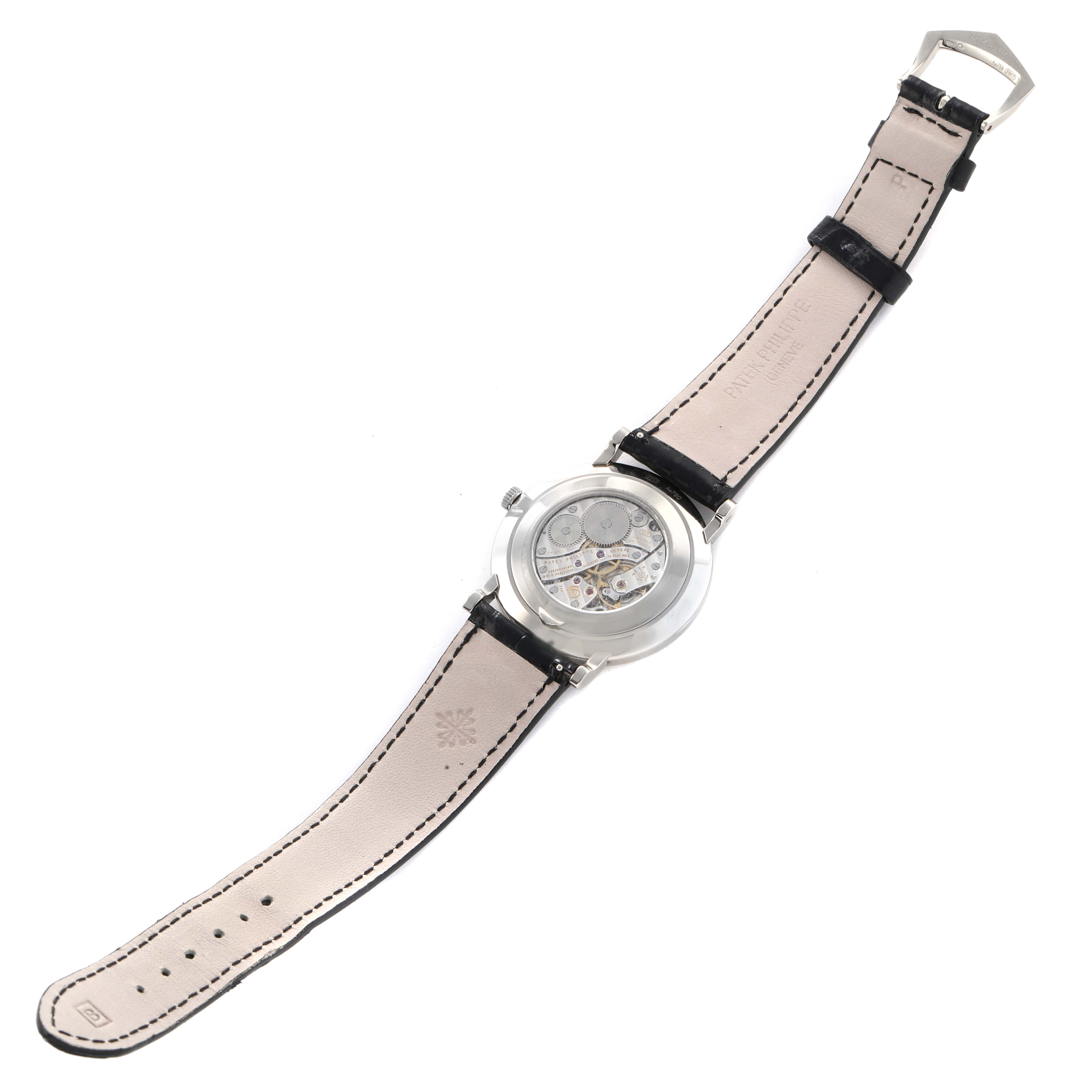 The image shows the back of a Patek Philippe Calatrava 5119G Men's White Gold White Dial, revealing its movement, strap, and buckle.