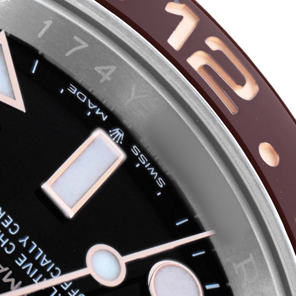 The image shows a close-up of the Rolex GMT-Master 126711 Men's Steel and Gold (two tone) Black Dial's dial and bezel, highlighting the hour markers and "12" on the bezel.