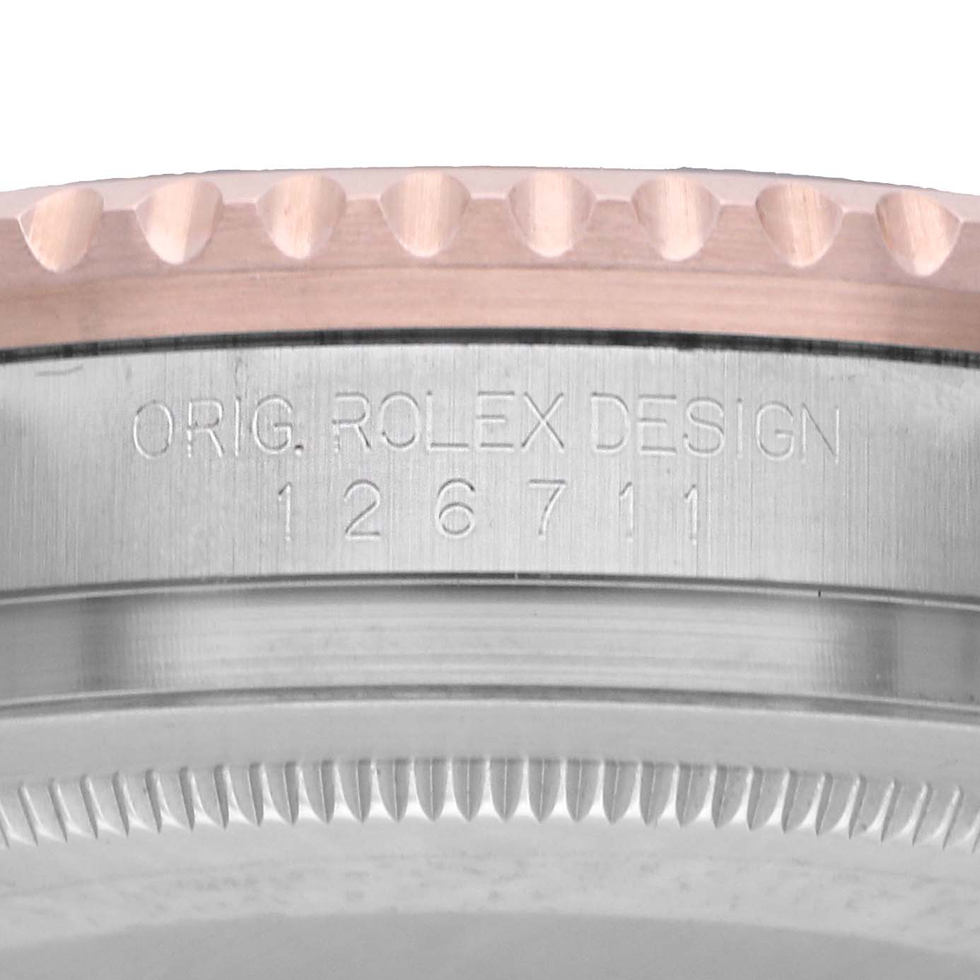 The image shows a side profile of the Rolex GMT-Master 126711 Men's Steel and Gold (two tone) Black Dial model, focusing on the bezel and case with etched details.