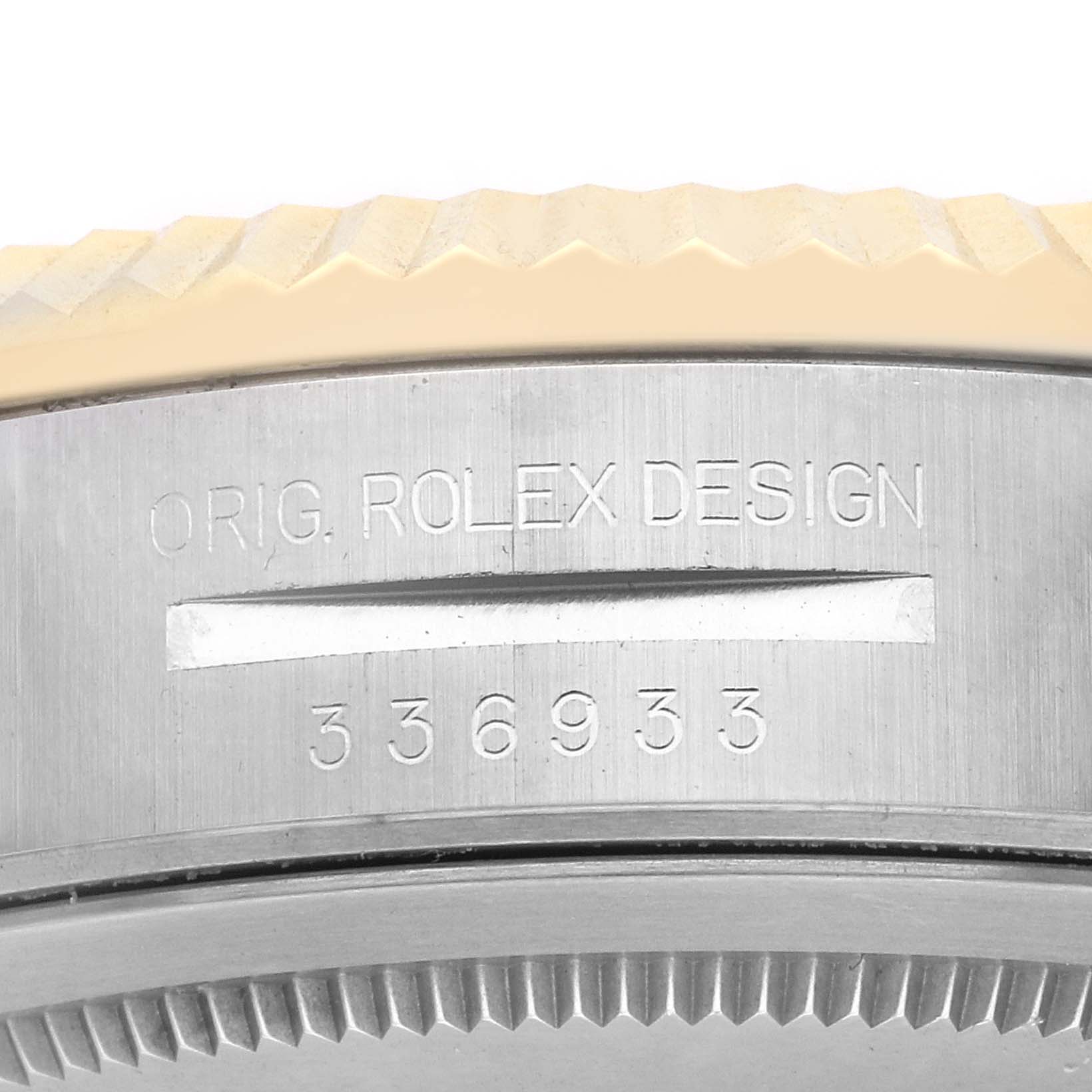 The image shows a close-up of the side of a Rolex Sky-Dweller 336933 Men's Steel and Gold (two tone) Silver Dial, highlighting the engraved serial number and "ORIG. ROLEX DESIGN."