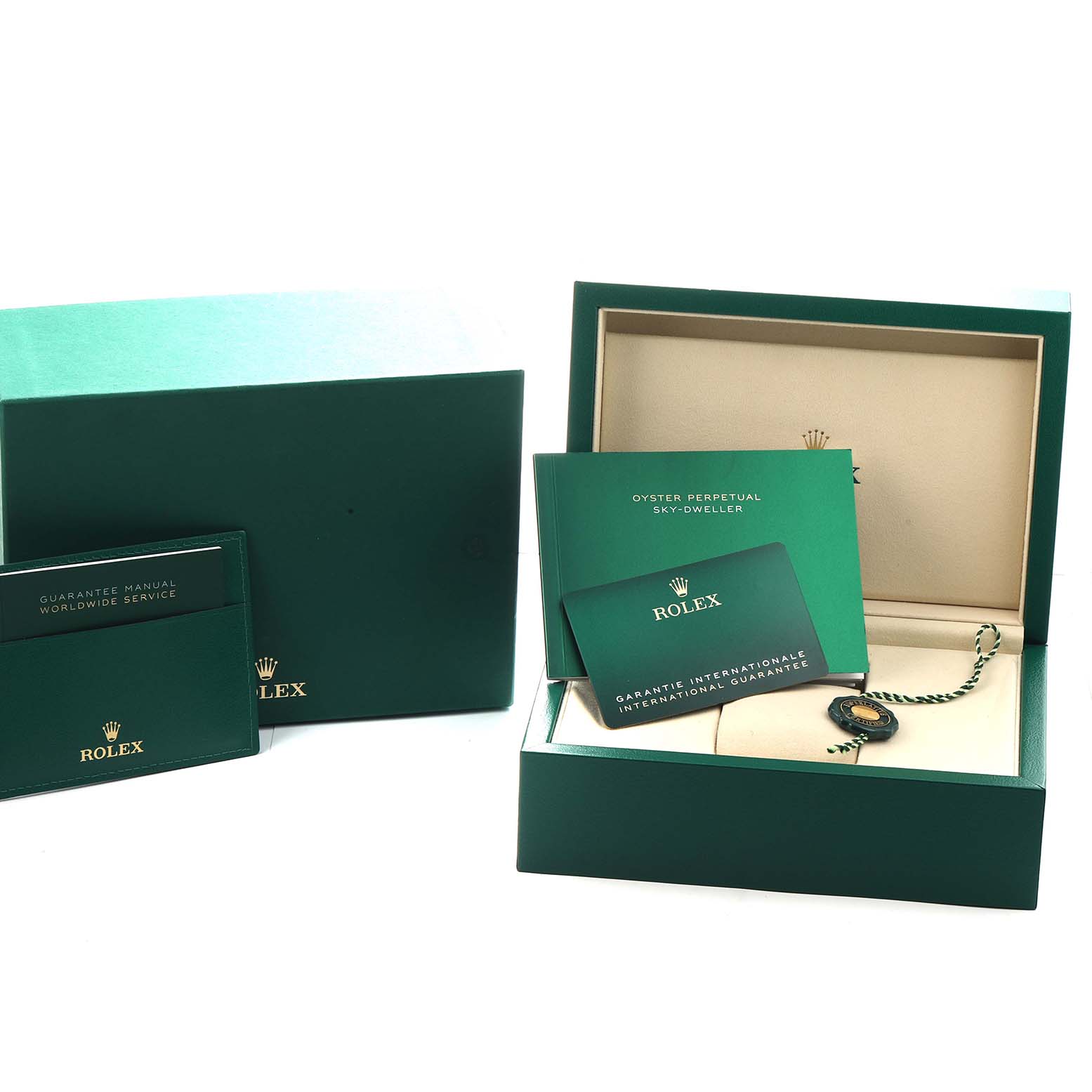 The image shows the packaging and documentation for a Rolex Sky-Dweller 336933 Men's Steel and Gold (two tone) Silver Dial, including the box, manuals, and warranty card.