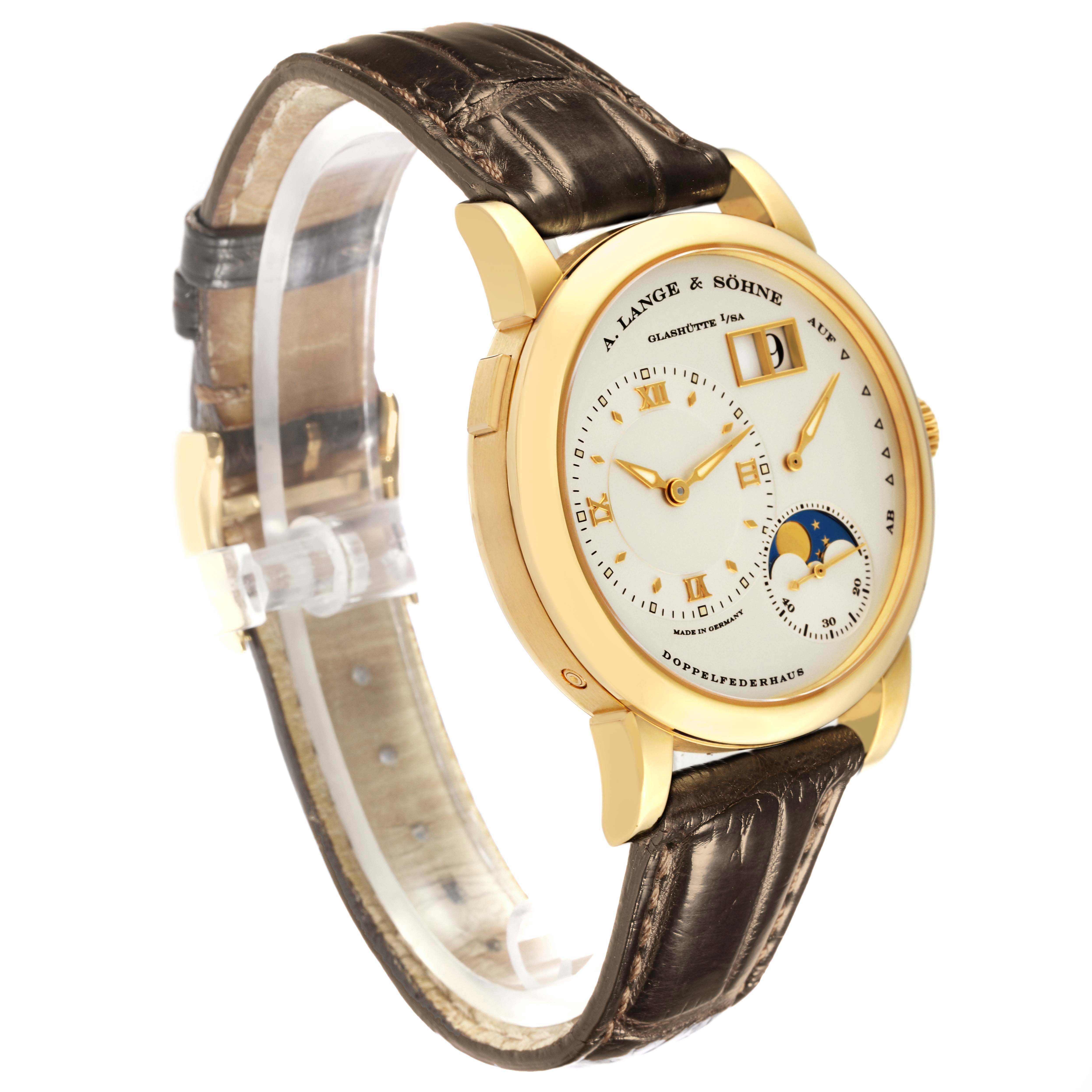 The Lange 1 by A. Lange & Söhne is shown at a three-quarter angle, displaying the dial, case, and leather strap.