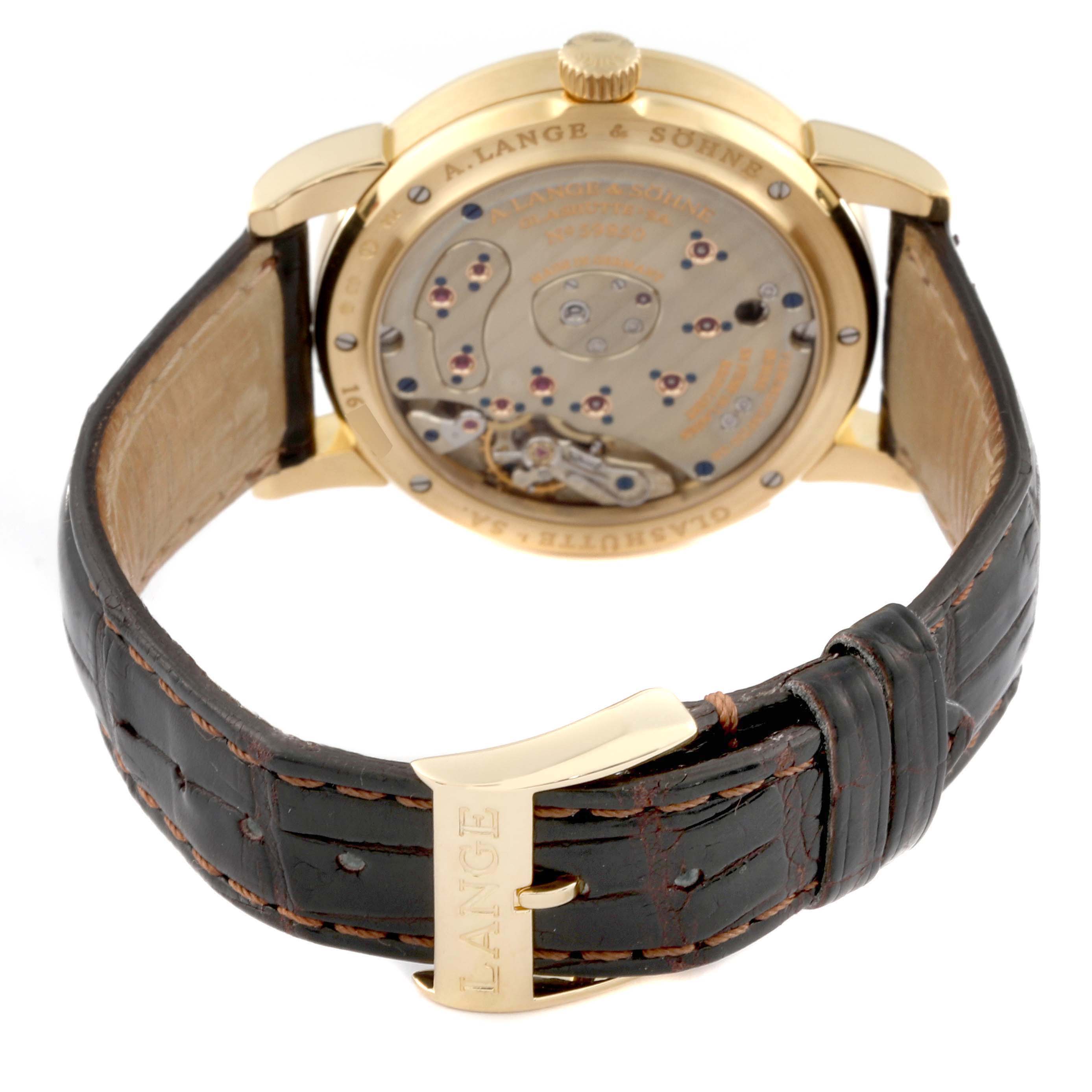 The image shows the back view of the A. Lange & Sohne Lange 1 109.021 Men's Yellow Gold Silver Dial watch, highlighting its movement and leather strap.