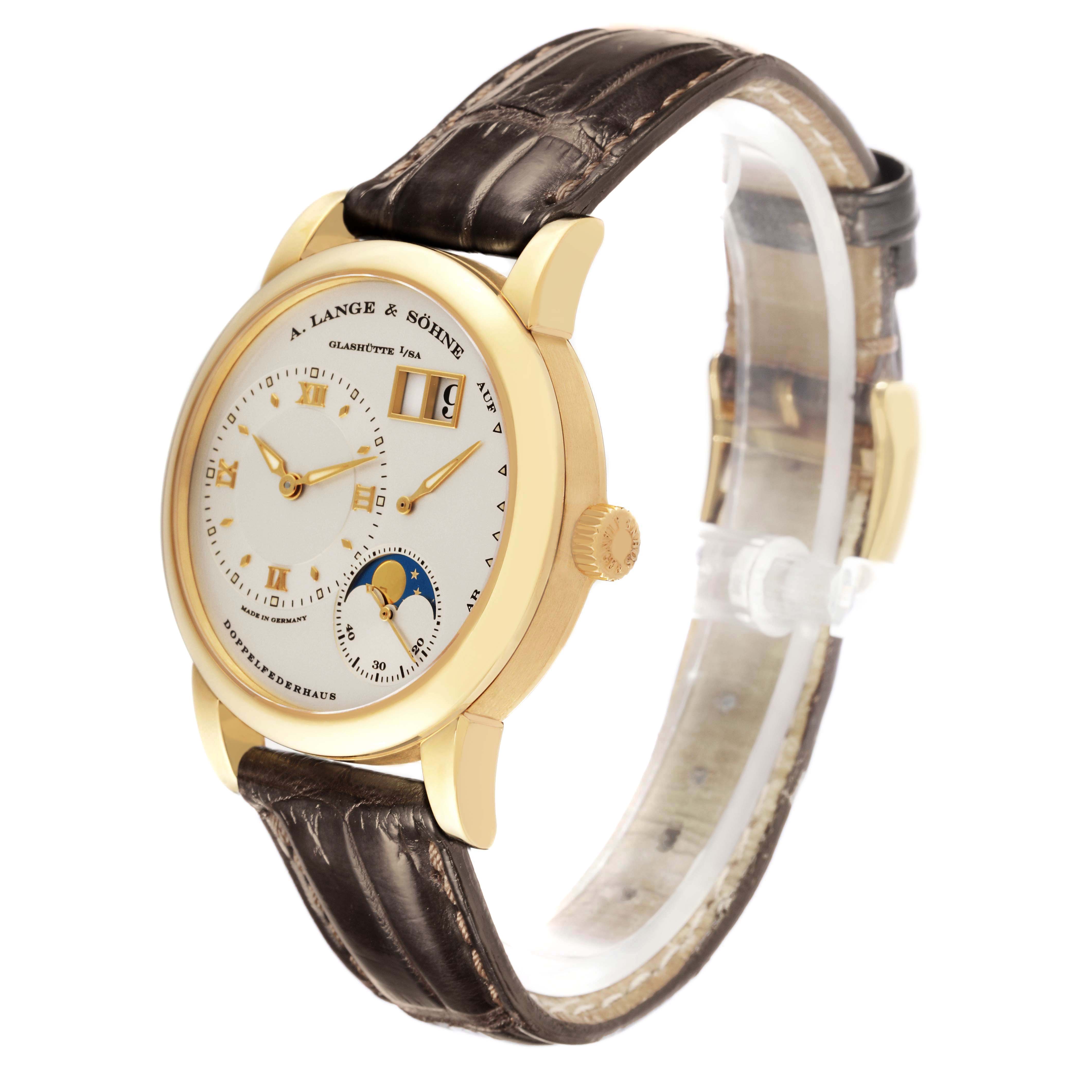 The A. Lange & Sohne Lange 1 109.021 Men's Yellow Gold Silver Dial watch is shown at a slight angle, highlighting the case, dial, strap, and side crown.