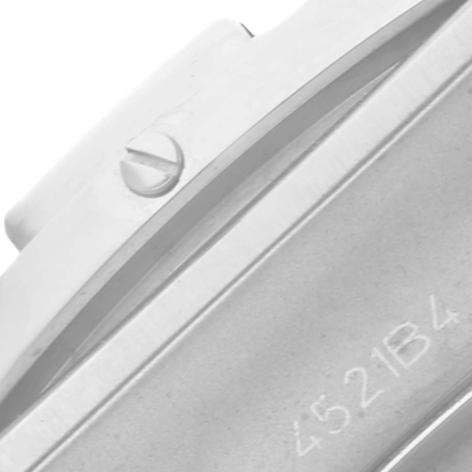 The image shows a close-up angle of a screw and serial number on the casing of a Breitling Chronomat AB0134 Men's Stainless Steel Silver Dial AB0134 Men's Stainless Steel Silver Dial watch.