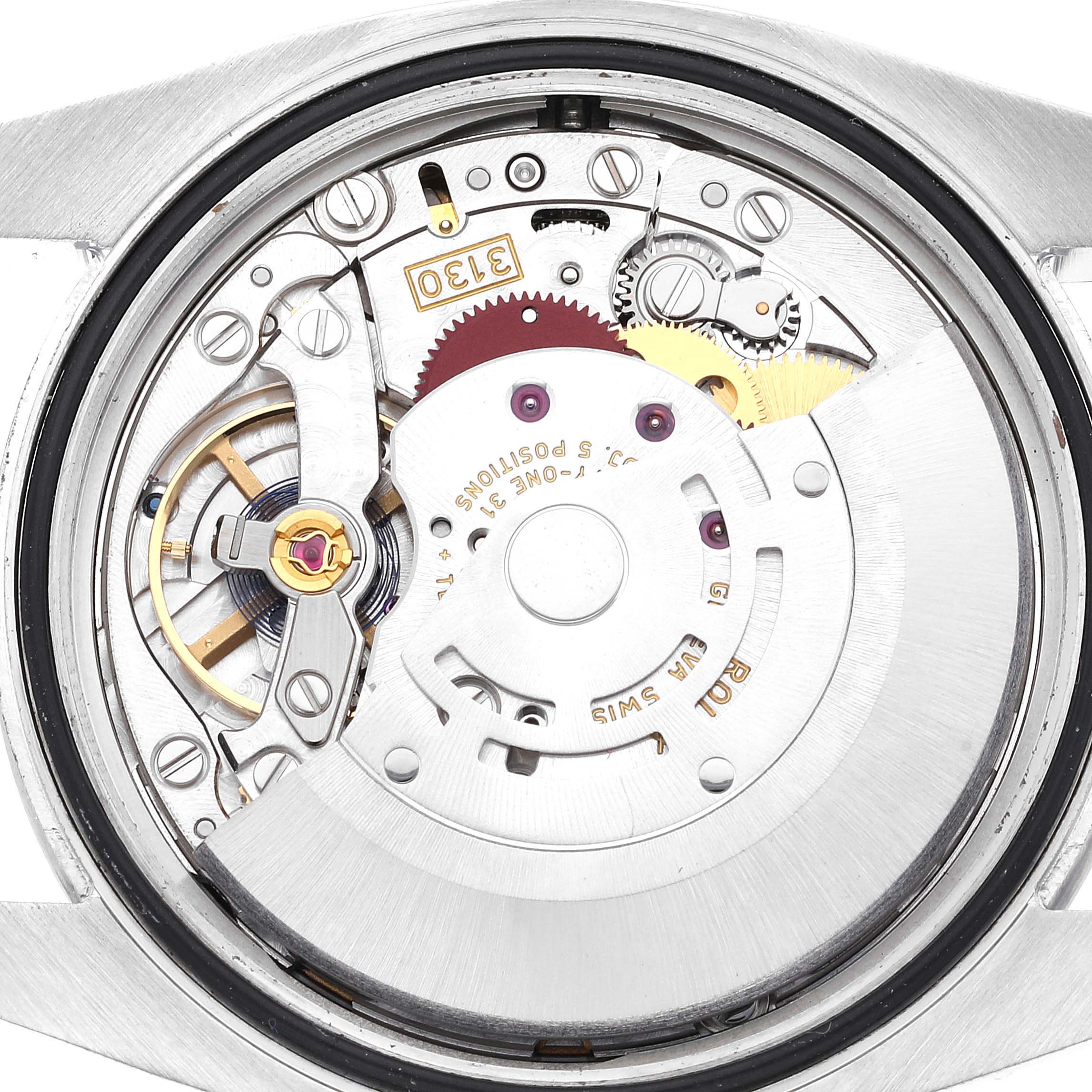 The image shows a close-up view of the movement mechanism of a Rolex Oyster Perpetual 116000 Men's Stainless Steel Purple Dial 116000 Men's Stainless Steel Purple Dial watch.