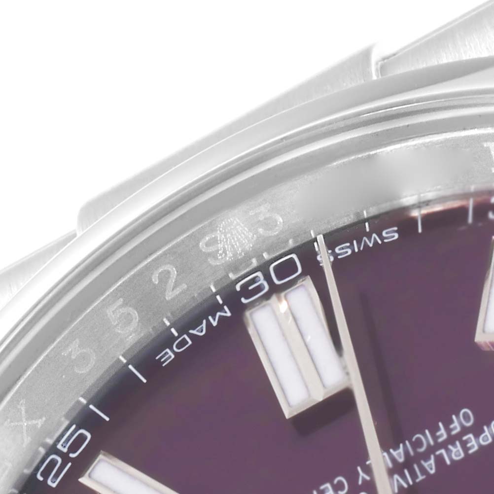 This close-up image shows the top portion of the dial and bezel of a Rolex Oyster Perpetual 116000 Men's Stainless Steel Purple Dial 116000 Men's Stainless Steel Purple Dial watch.