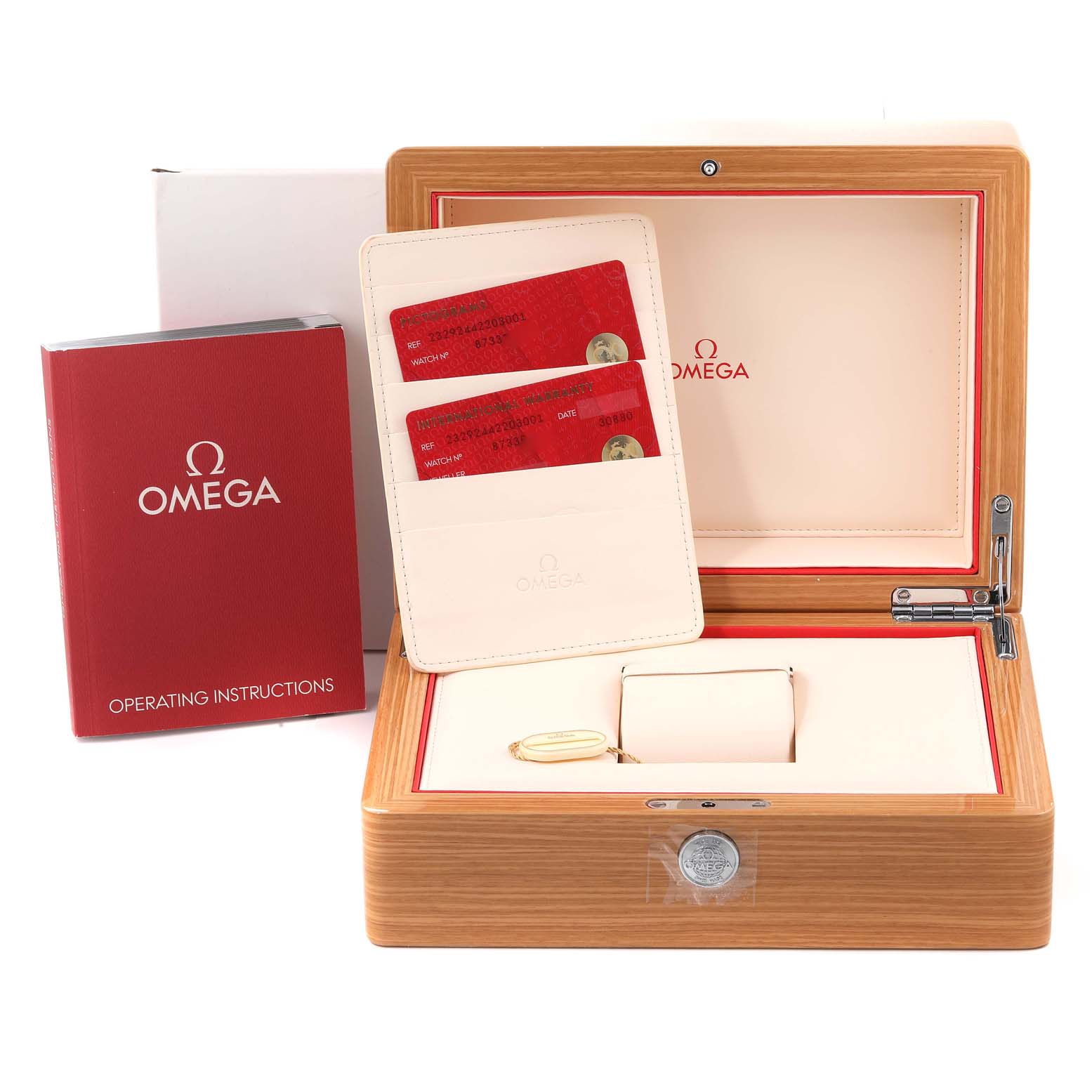 The image shows the open wooden box, operating instructions, and warranty cards for the Omega Planet Ocean 232.92.44.22.03.001 Men's Stainless Steel Blue Dial 232.92.44.22.03.001 Men's Stainless Steel Blue Dial watch.