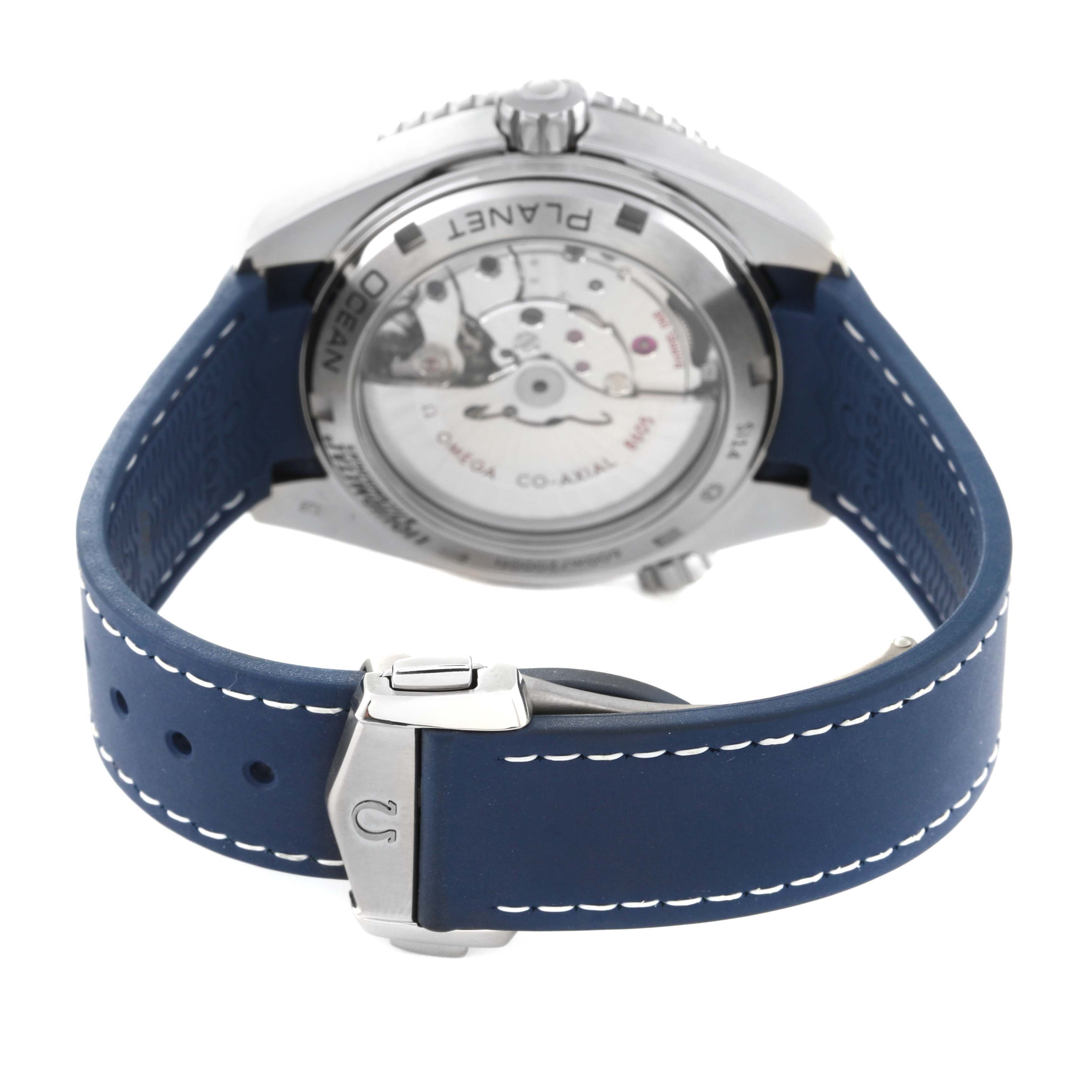 The image shows the back view of the Omega Planet Ocean 232.92.44.22.03.001 Men's Stainless Steel Blue Dial 232.92.44.22.03.001 Men's Stainless Steel Blue Dial watch, highlighting its movement and blue strap with buckle.