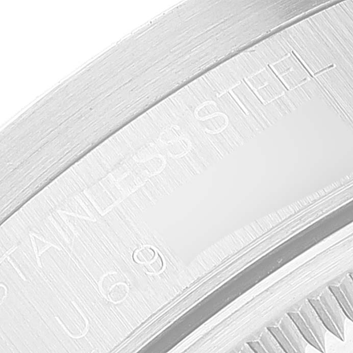 The image shows a close-up of the back case edge of a Rolex Date 15210 Men's Stainless Steel Black Dial 15210 Men's Stainless Steel Black Dial model watch, indicating "Stainless Steel."