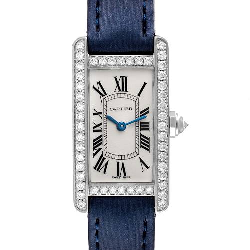 The image shows a head-on view of the Cartier Tank Americaine WB7018L1 Women's White Gold Silver Dial WB7018L1 Women's White Gold Silver Dial watch, highlighting its rectangular face, blue strap, and diamond bezel.