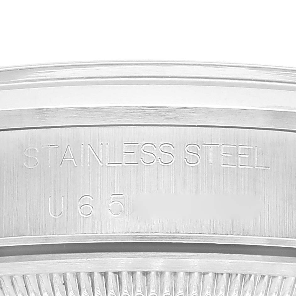 The image shows a close-up of the case back edge of a Rolex Date 15200 Men's Stainless Steel Black Dial 15200 Men's Stainless Steel Black Dial model watch, highlighting the "STAINLESS STEEL" engraving.