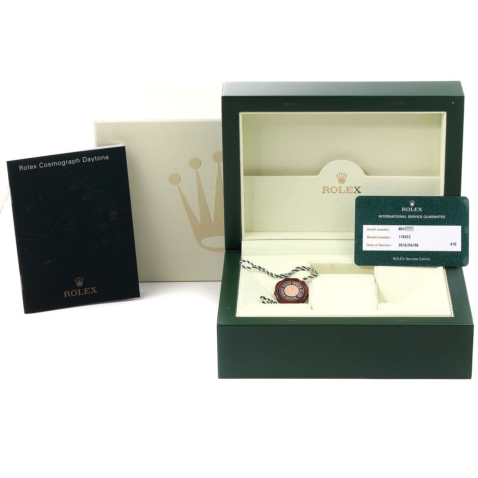 The image shows a Rolex Daytona 116523 Men's Steel and Gold (two tone) Mother of Pearl Dial 116523 Men's Steel and Gold (two tone) Mother of Pearl Dial watch box, an international guarantee card, a booklet, and a tag on a flat surface.