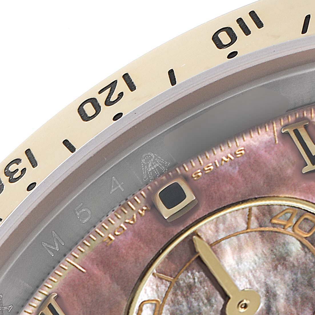 This image shows a close-up of the bezel and part of the dial of a Rolex Daytona 116523 Men's Steel and Gold (two tone) Mother of Pearl Dial 116523 Men's Steel and Gold (two tone) Mother of Pearl Dial watch.
