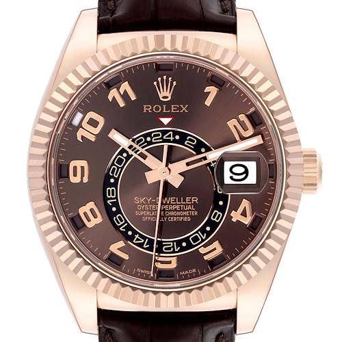 The image shows a frontal view of a Rolex Sky-Dweller 326135 Men's Rose Gold Brown Dial 326135 Men's Rose Gold Brown Dial, highlighting the dial, bezel, and date window.
