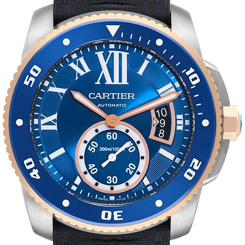 The Calibre de Cartier watch is shown from the front, displaying the blue dial, bezel, hands, and part of the crown.