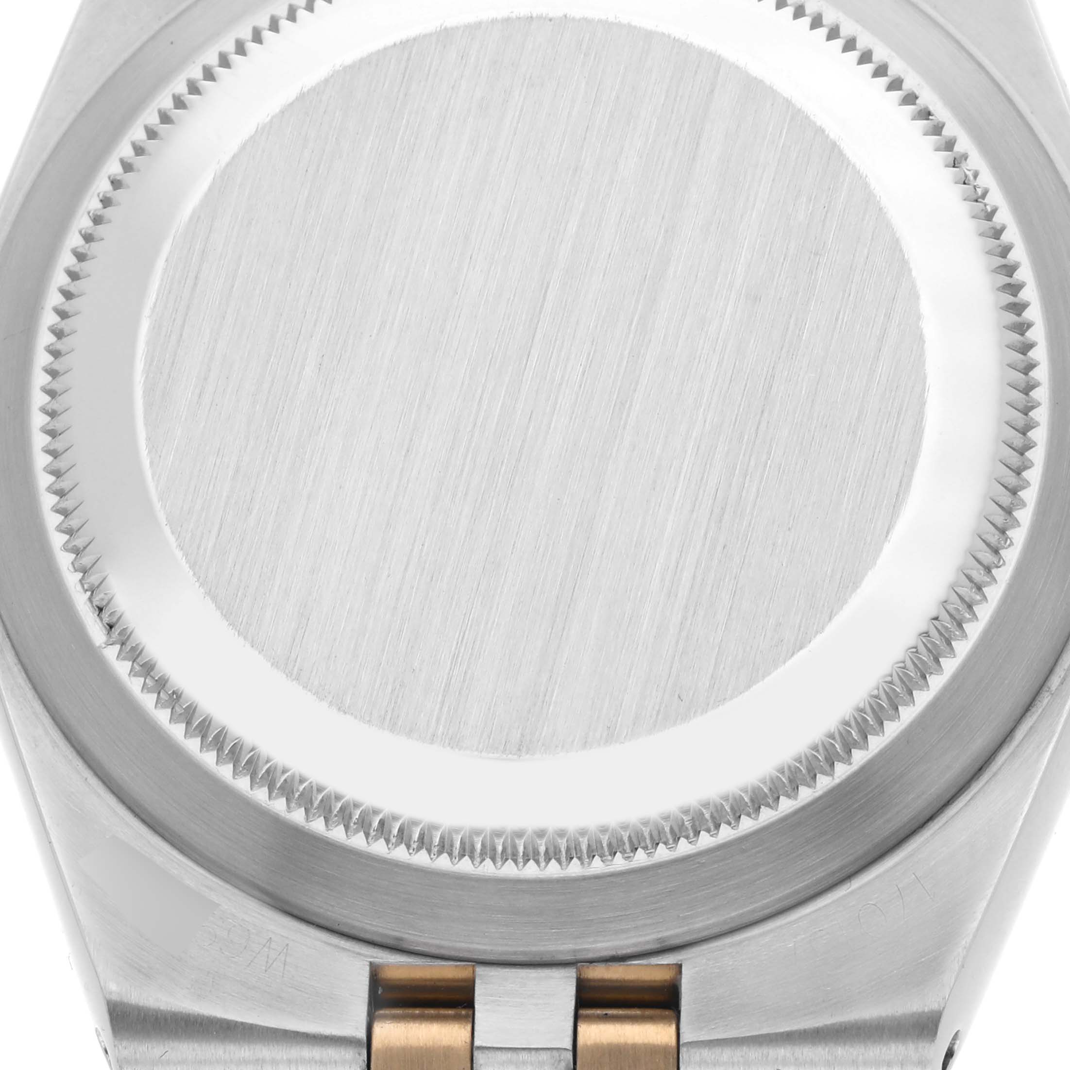 The image shows the back case and part of the bracelet of the Rolex Oysterquartz 17013 Men's Steel and Gold (two tone) Silver Dial 17013 Men's Steel and Gold (two tone) Silver Dial watch from a top-down angle.