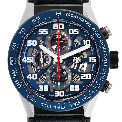 The image shows a frontal view of the Tag Heuer Carrera CAR2A1N.FT6100 Men's Stainless Steel Blue Dial CAR2A1N.FT6100 Men's Stainless Steel Blue Dial watch, highlighting its tachymeter bezel, chronograph sub-dials, and skeleton dial.
