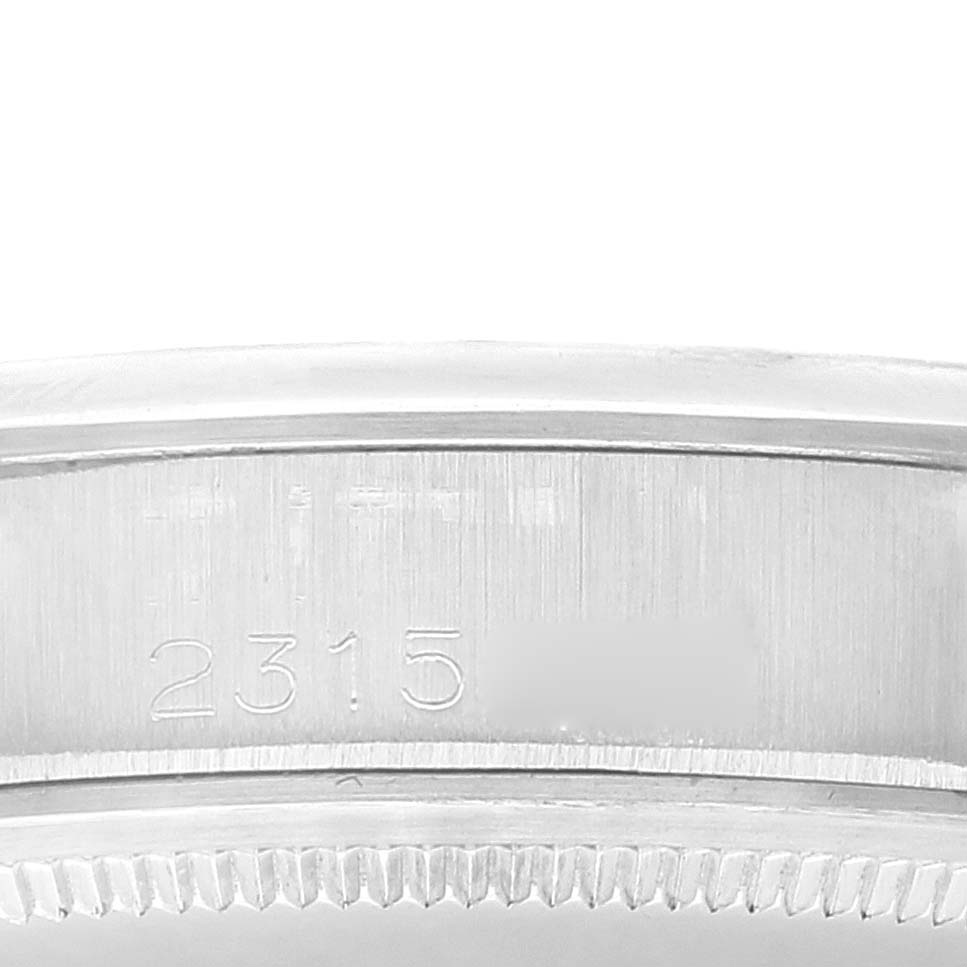 The image shows a close-up of the case side of the Rolex Date 1500 Men's Stainless Steel Silver Dial 1500 Men's Stainless Steel Silver Dial model watch, with a partial view of the serial number engraving.