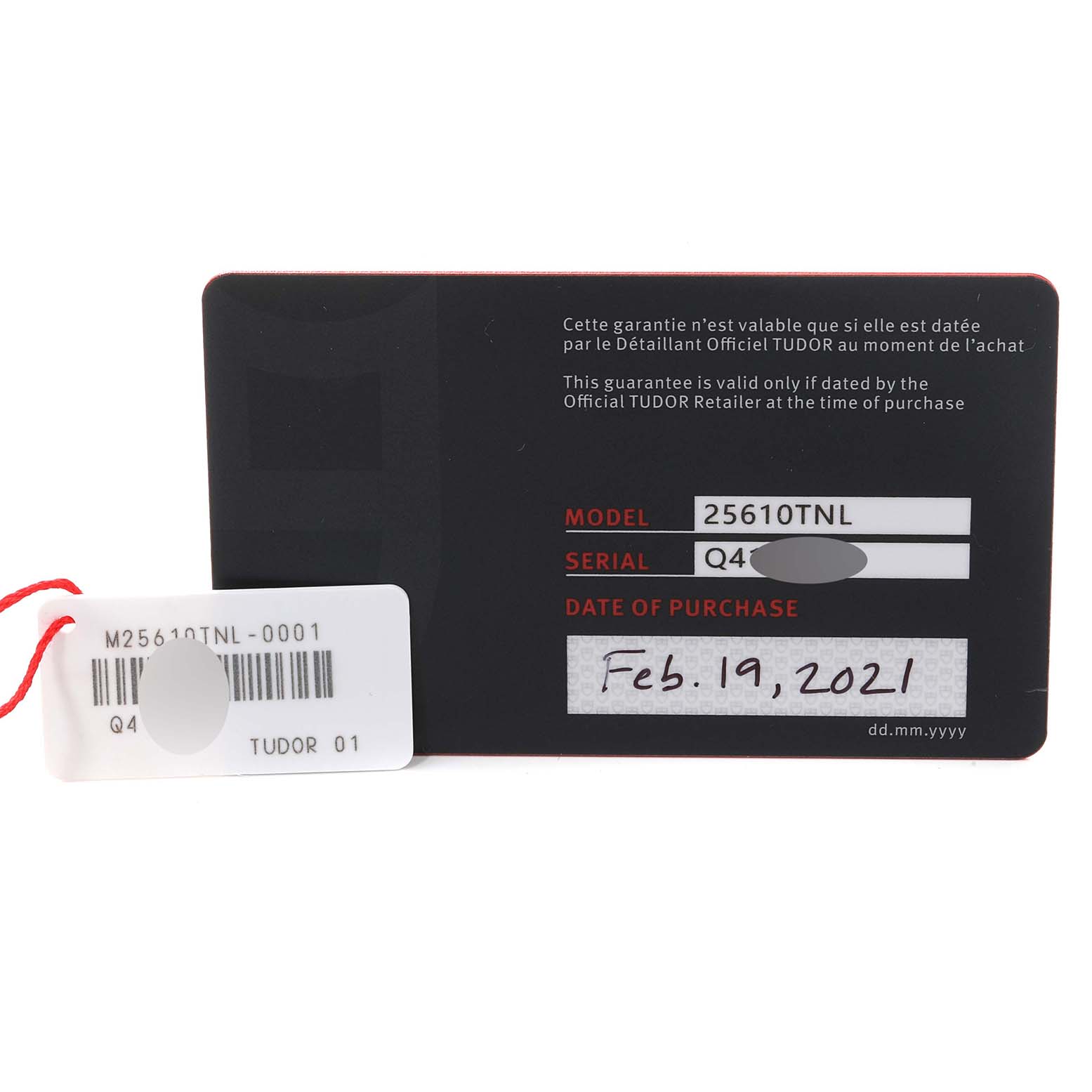 The image shows the warranty card and a tag for the Tudor Pelagos 25610TNL Men's Titanium Black Dial 25610TNL Men's Titanium Black Dial model 25610TNL watch, including serial and purchase date details.