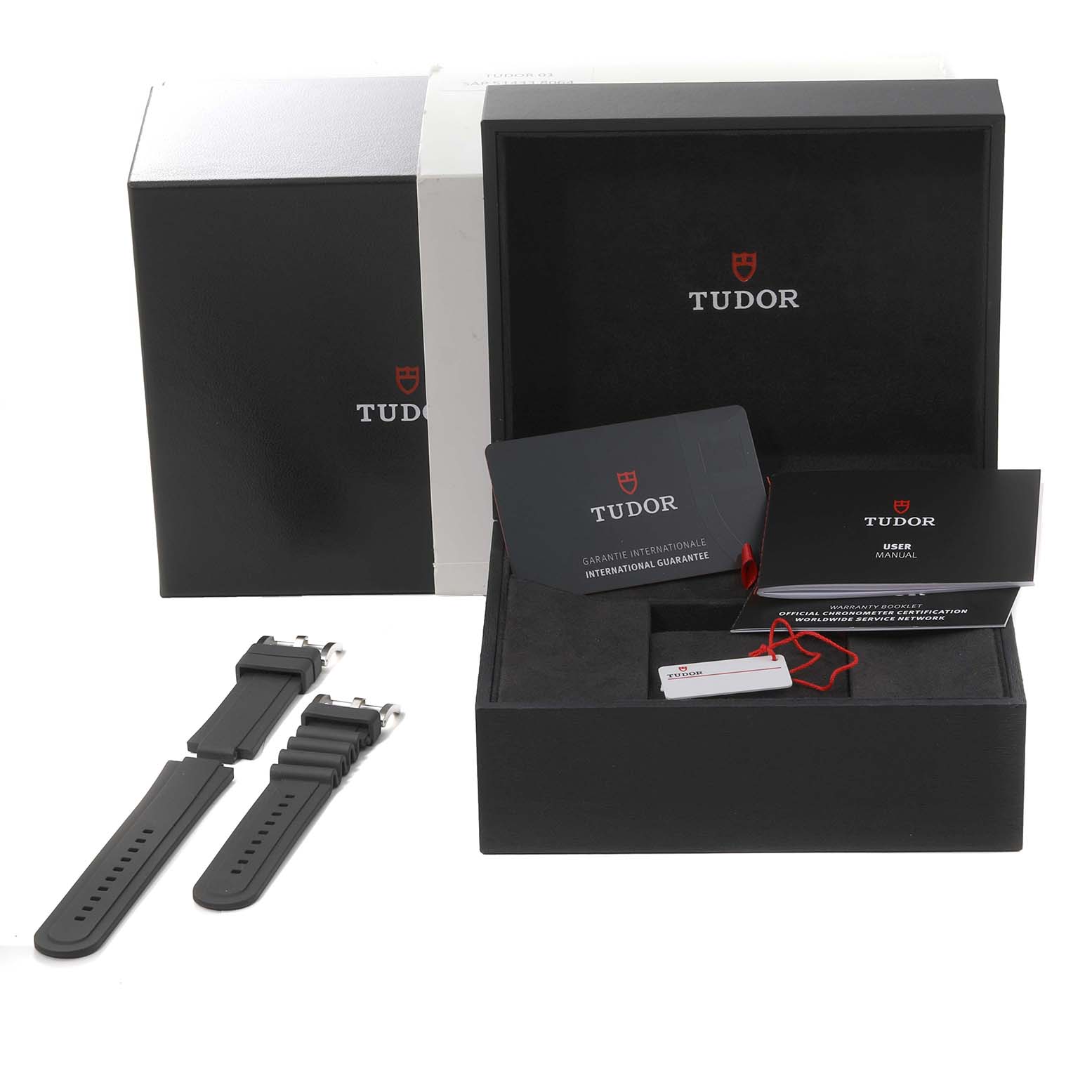 The image shows the packaging, user manual, international guarantee card, spare straps, and accessories for a Tudor Pelagos 25610TNL Men's Titanium Black Dial 25610TNL Men's Titanium Black Dial watch.