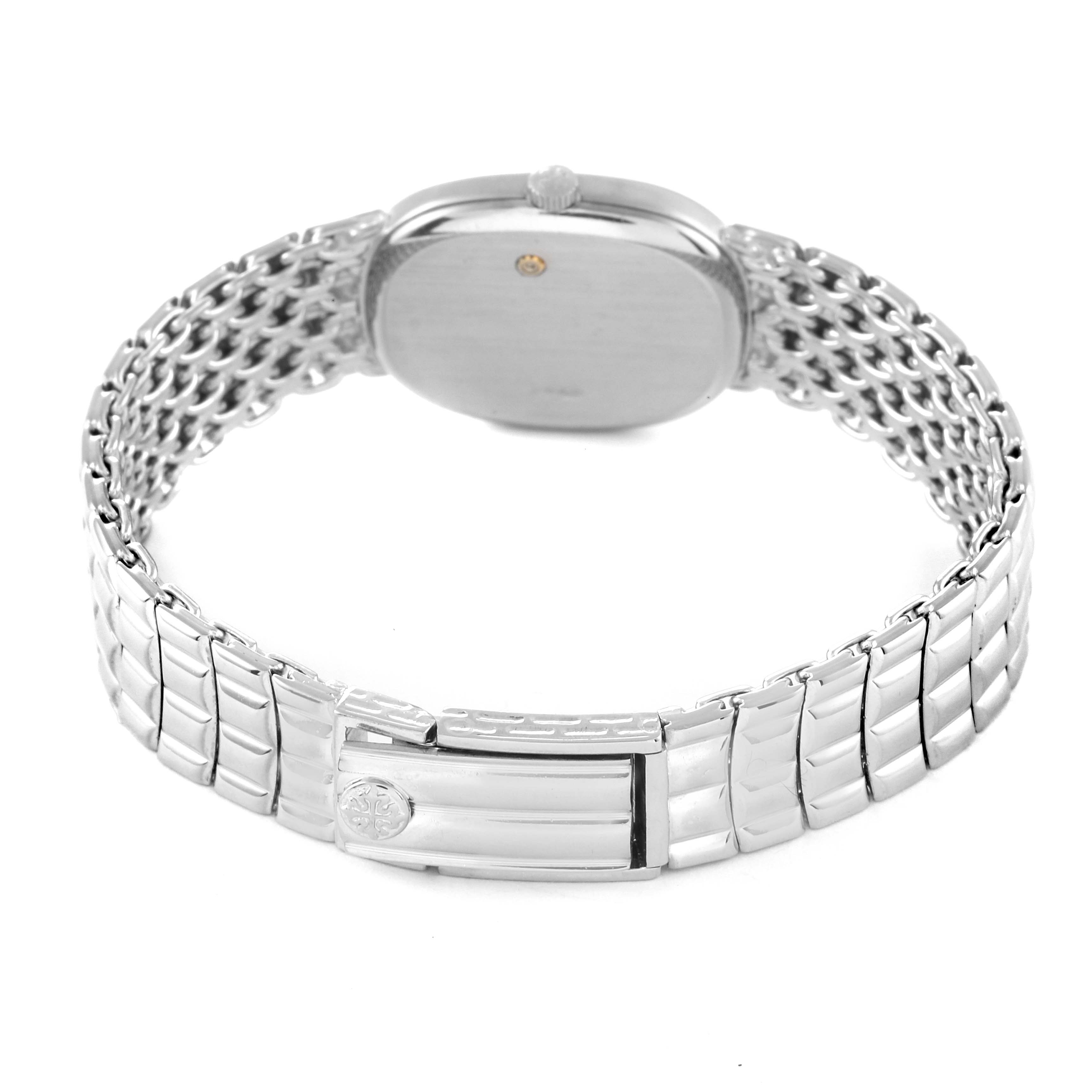 The image shows the back view of the Patek Philippe Golden Ellipse 4764/15 Women's White Gold Silver Dial 4764/15 Women's White Gold Silver Dial watch, highlighting its case, crown, and metal bracelet with the clasp.