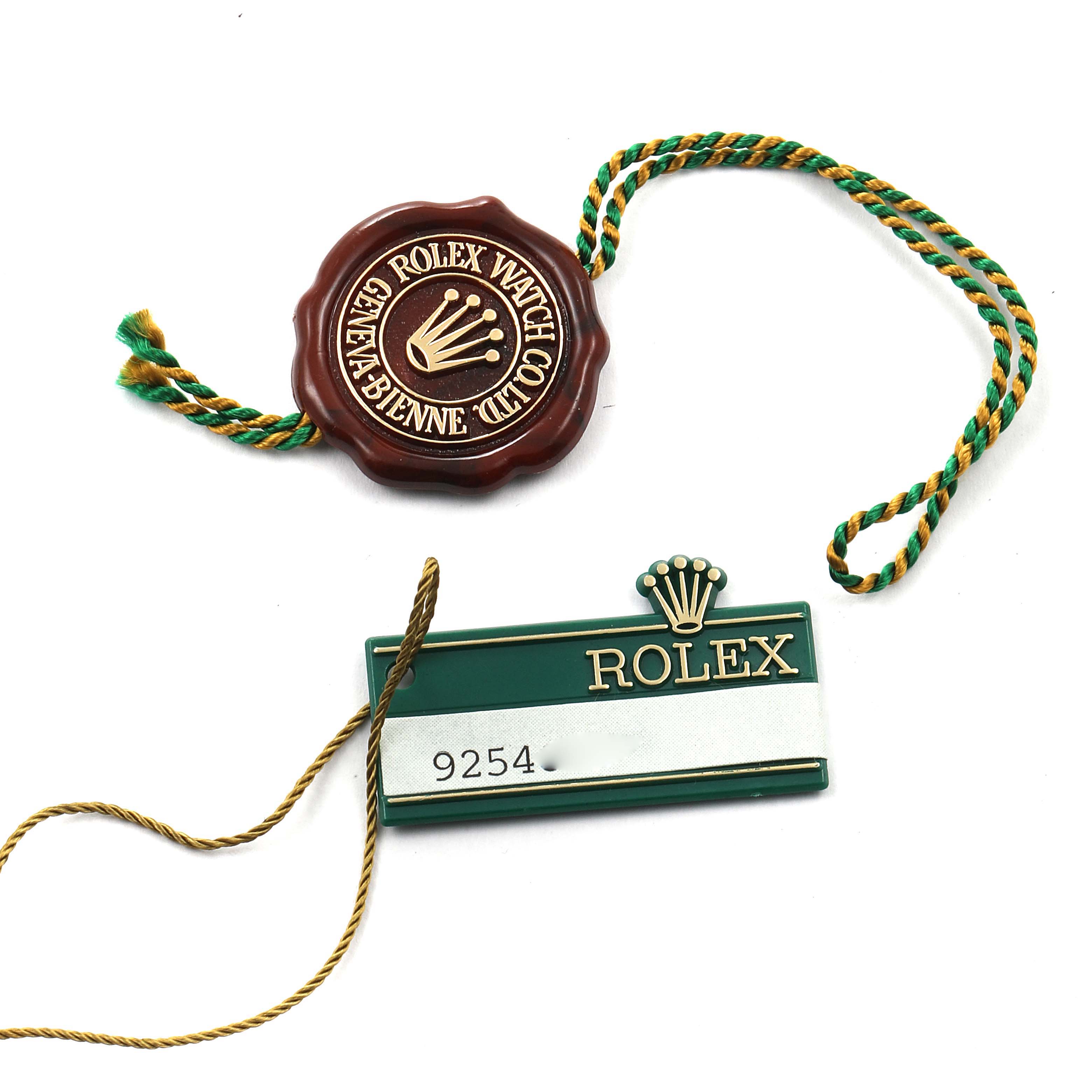 The image shows a Rolex Date 69160 Women's Stainless Steel Blue Dial 69160 Women's Stainless Steel Blue Dial model's tag and seal from a top-down angle.