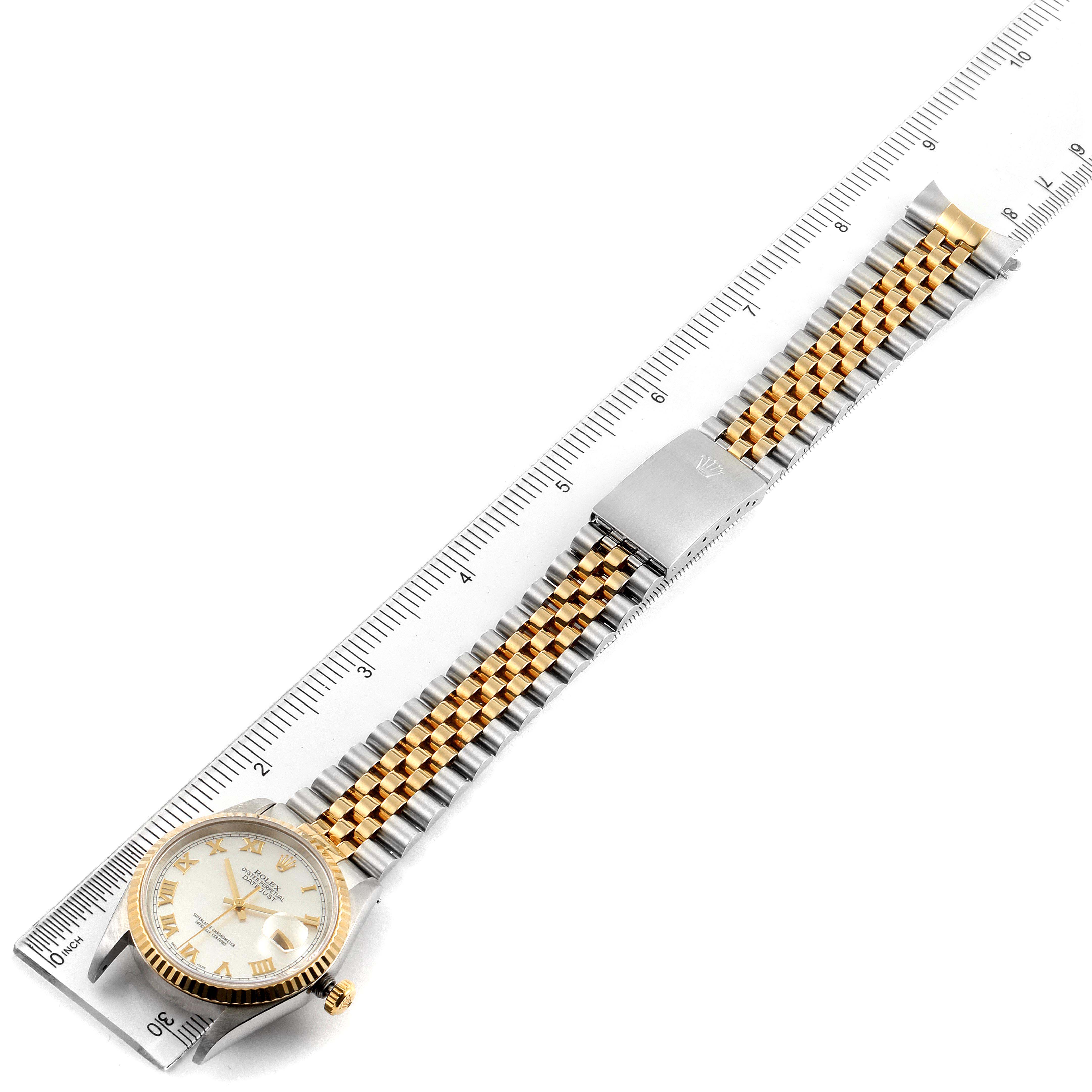 The image shows a Rolex Datejust 16233 Men's Steel and Gold (two tone) Mother of Pearl Dial 16233 Men's Steel and Gold (two tone) Mother of Pearl Dial watch laid flat with its dial, bracelet, and clasp fully visible against a ruler for scale.