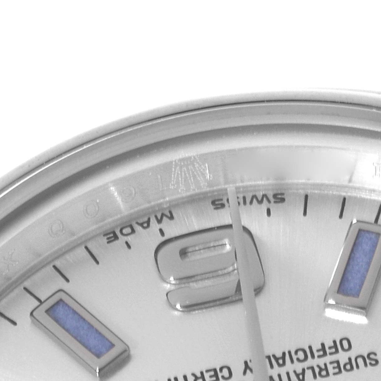 This image shows a close-up angle of a Rolex Oyster Perpetual 176200 Women's Stainless Steel Silver Dial 176200 Women's Stainless Steel Silver Dial watch, focusing on part of the dial, bezel, and hour markers.