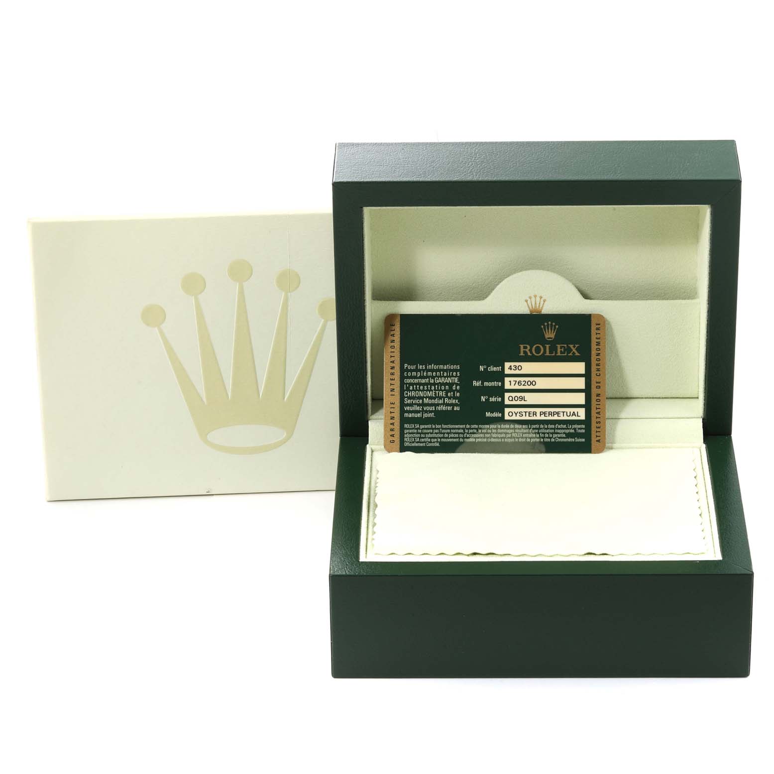 The image shows an open green Rolex box containing a warranty card for the Oyster Perpetual model.