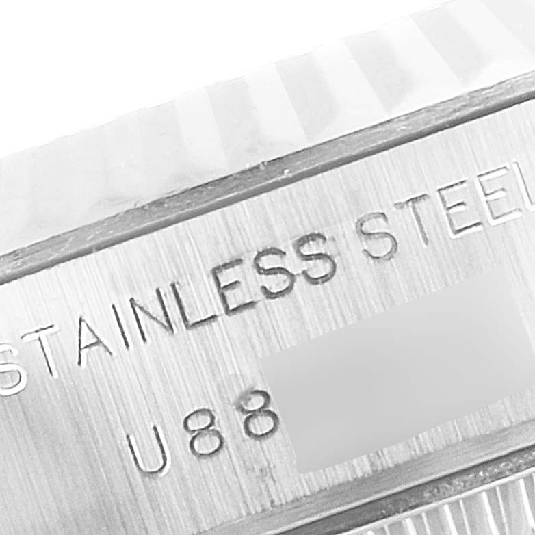 The image shows a close-up of the serial number and "STAINLESS STEEL" engraving on a Rolex Datejust 69174 Women's Stainless Steel Pink Dial 69174 Women's Stainless Steel Pink Dial watch.