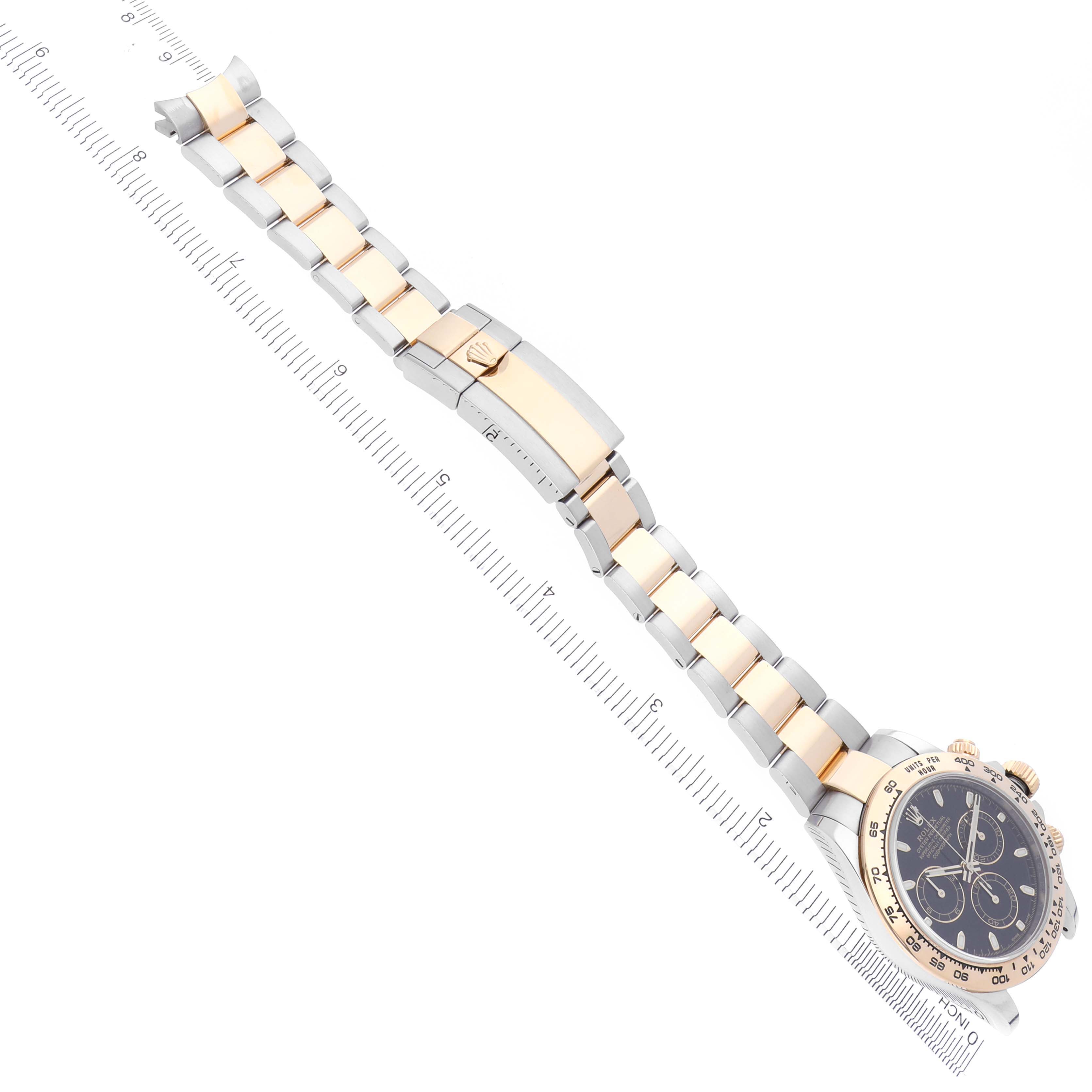 The Rolex Daytona 116503 Men's Steel and Gold (two tone) Black Dial 116503 Men's Steel and Gold (two tone) Black Dial watch is shown from a top-down angle, featuring the bracelet and clasp with the dial partially visible.