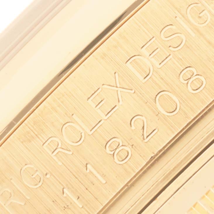 The image shows a close-up of the engraved side of a Rolex President 118208 Men's Yellow Gold Mother of Pearl Dial 118208 Men's Yellow Gold Mother of Pearl Dial model watch, highlighting the brand and model details.