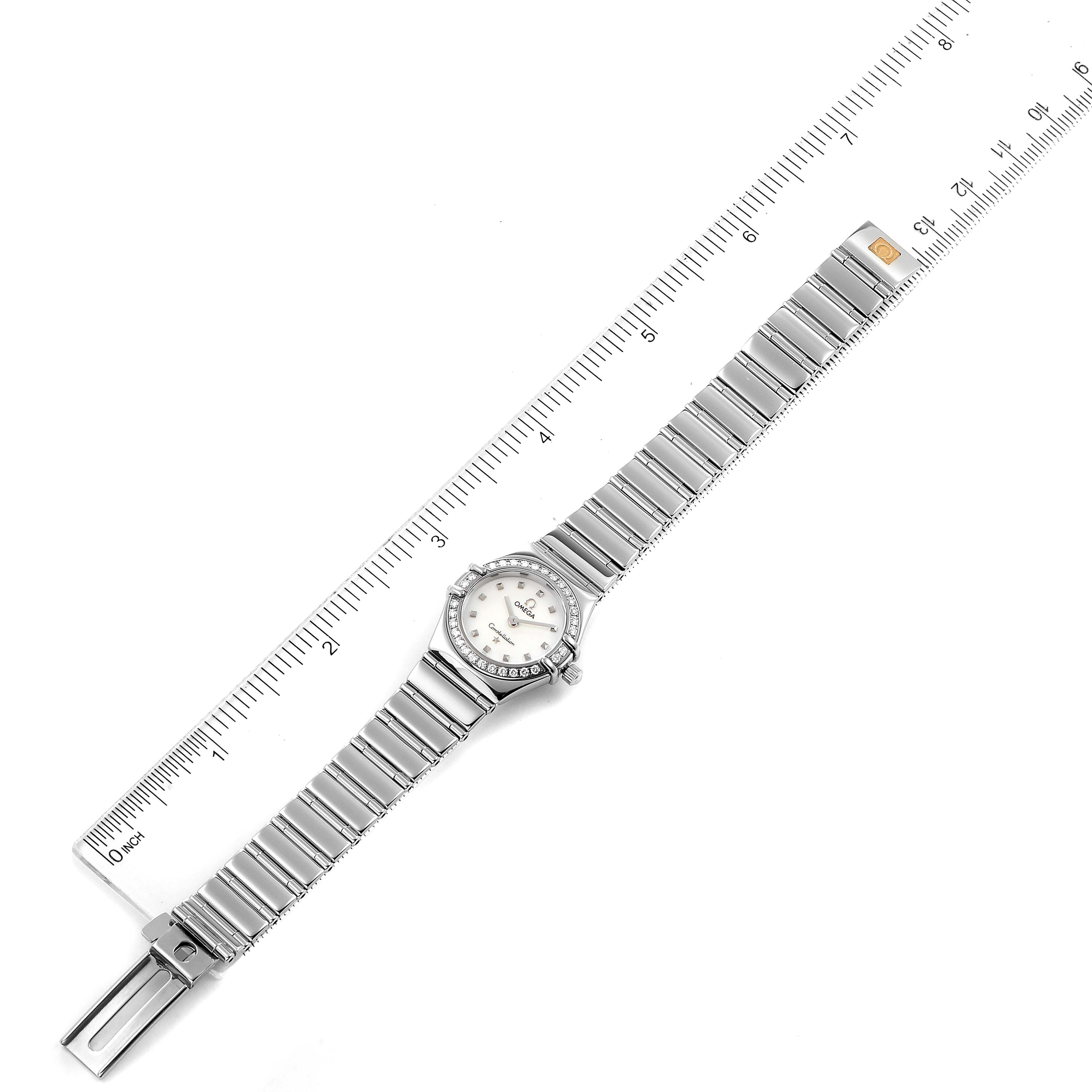 The image shows an overhead view of the Omega 1465.71.00 Women's Stainless Steel Mother of Pearl Dial 1465.71.00 Women's Stainless Steel Mother of Pearl Dial Constellation My Choice Diamond Steel Ladies Watch 1465.71.00 alongside a ruler.
