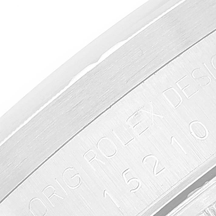 This image shows a close-up view of the inner bezel of a Rolex Date 15210 Men's Stainless Steel White Dial 15210 Men's Stainless Steel White Dial model watch, revealing part of the engraved serial number.