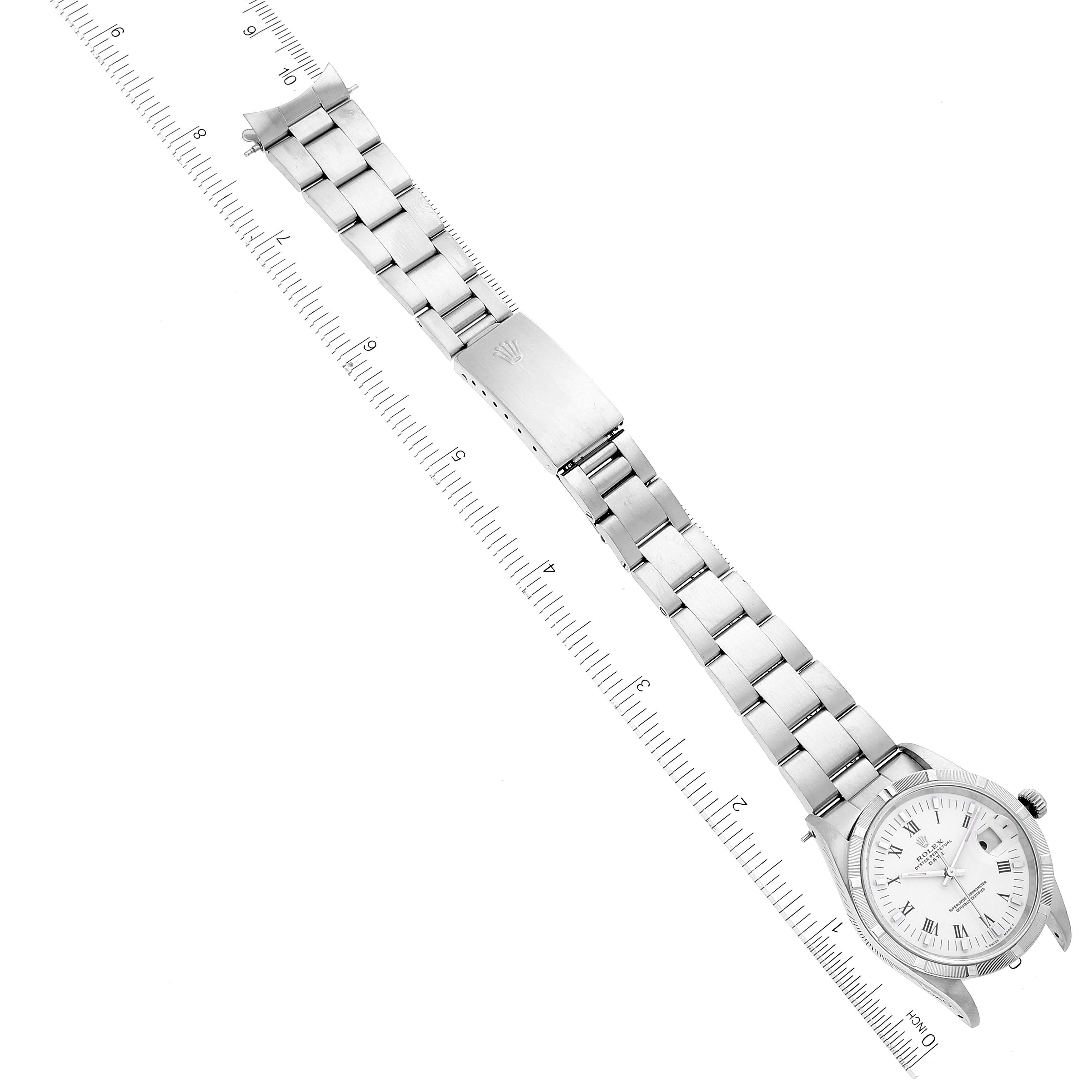 The image shows a Rolex Date 15210 Men's Stainless Steel White Dial 15210 Men's Stainless Steel White Dial model watch laid out flat with a focus on the full bracelet and the case, measured against a ruler.